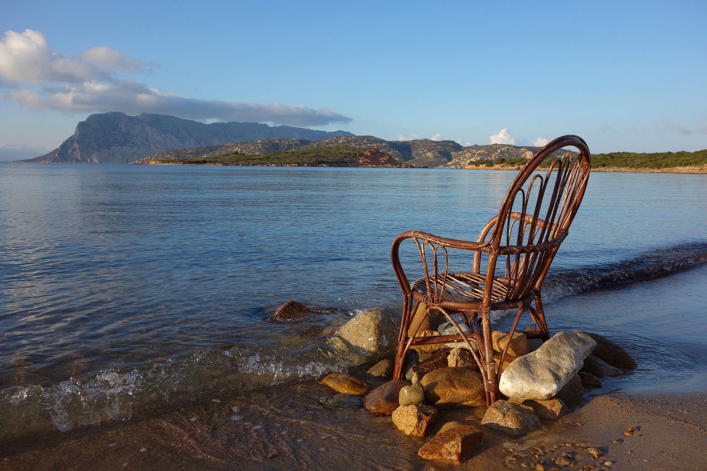 Sardinia, chair on the sea shore in Capo Coda Cavallo