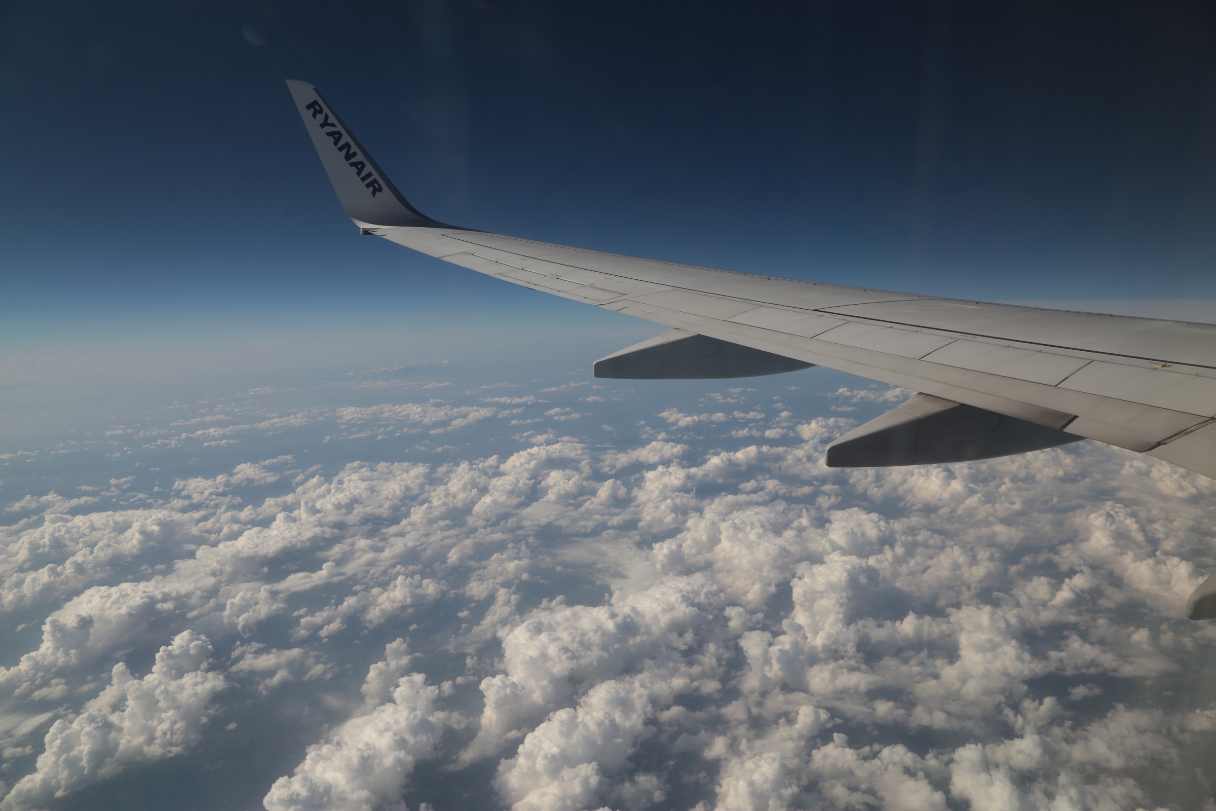 the sky is blue above the clouds