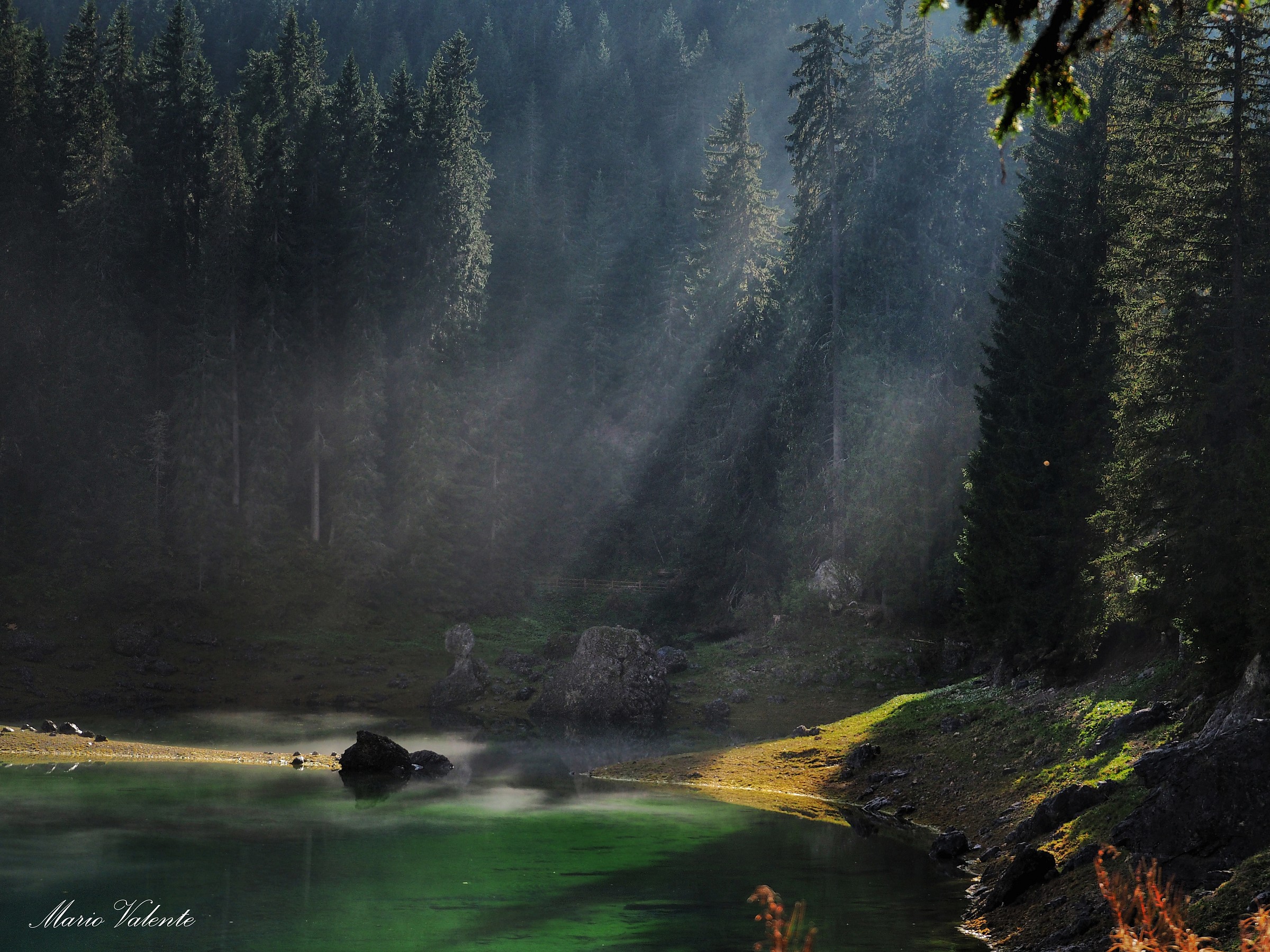 Rays in the mist rising from the lake