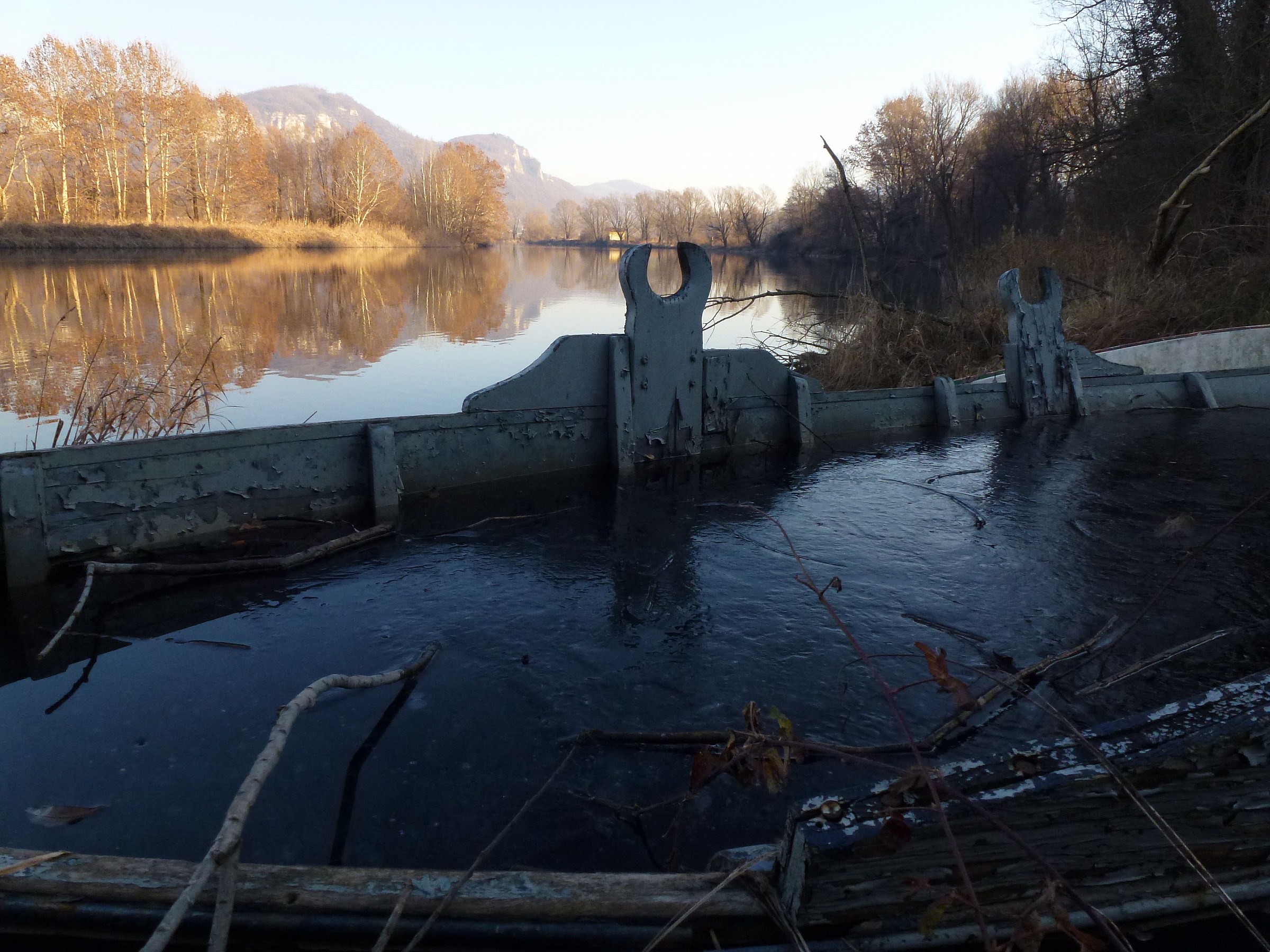 Ice in the abandoned boat on the shore
