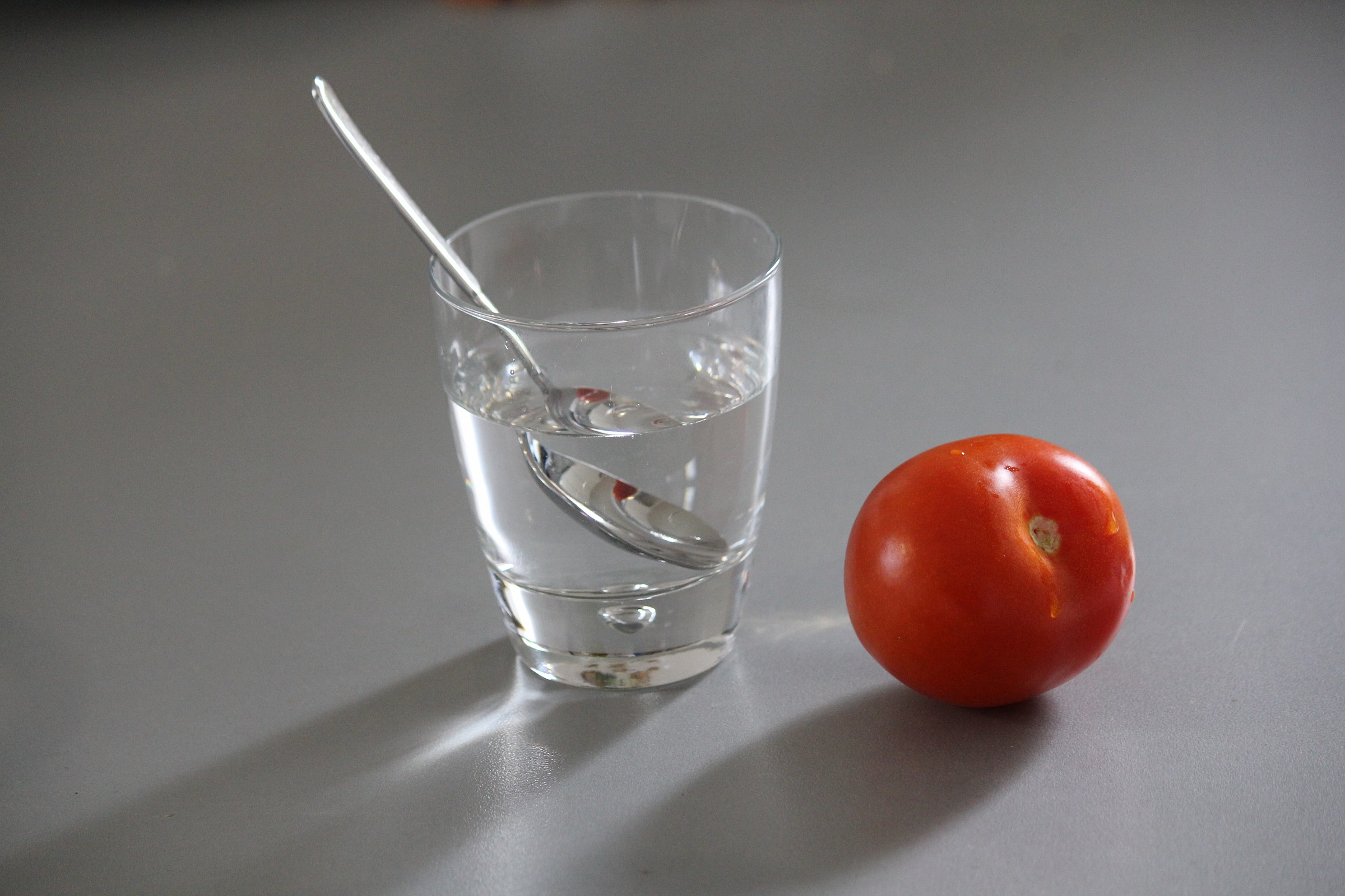 glass, spoon and tomato