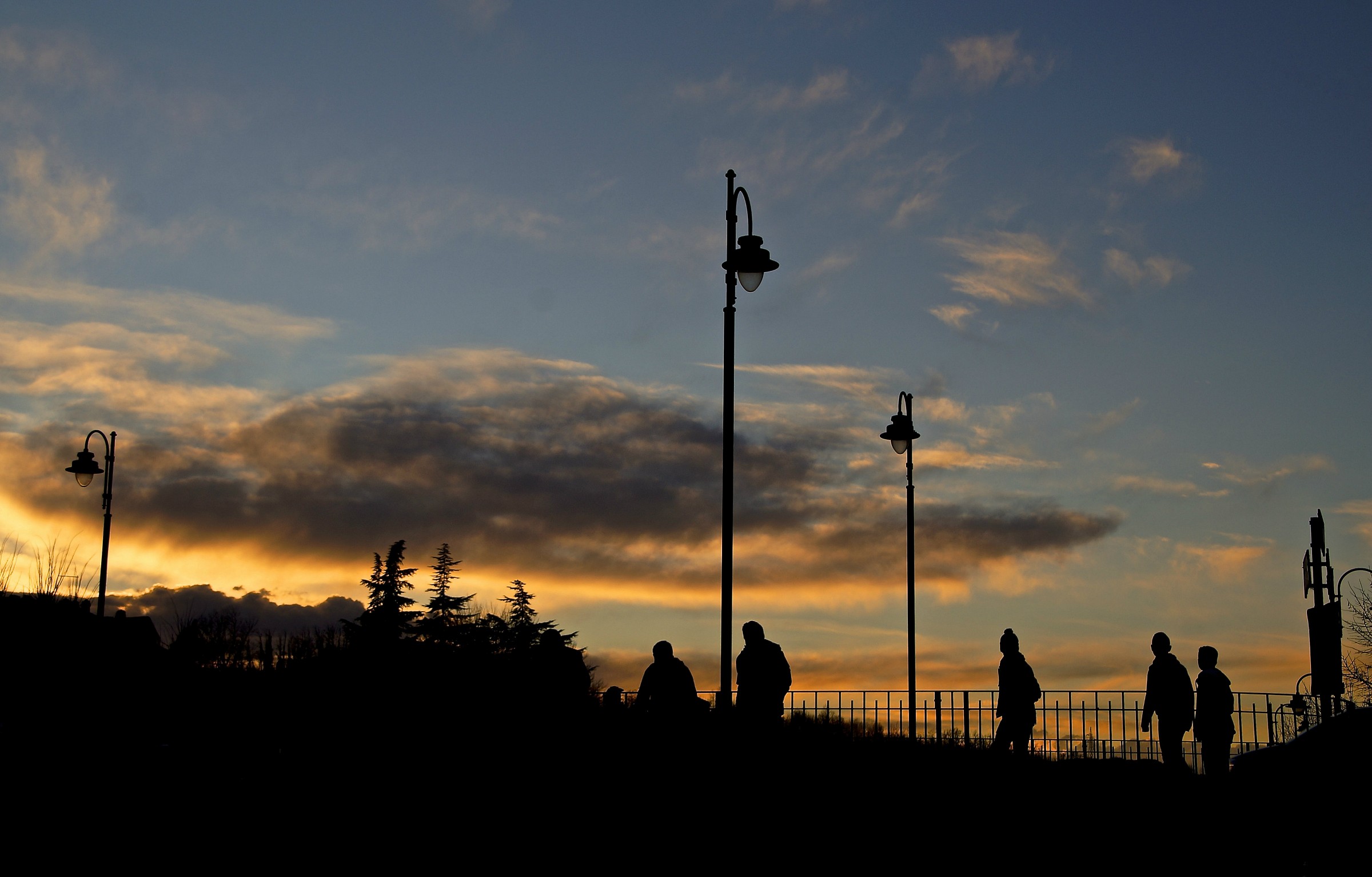 Above all of them fell sunset