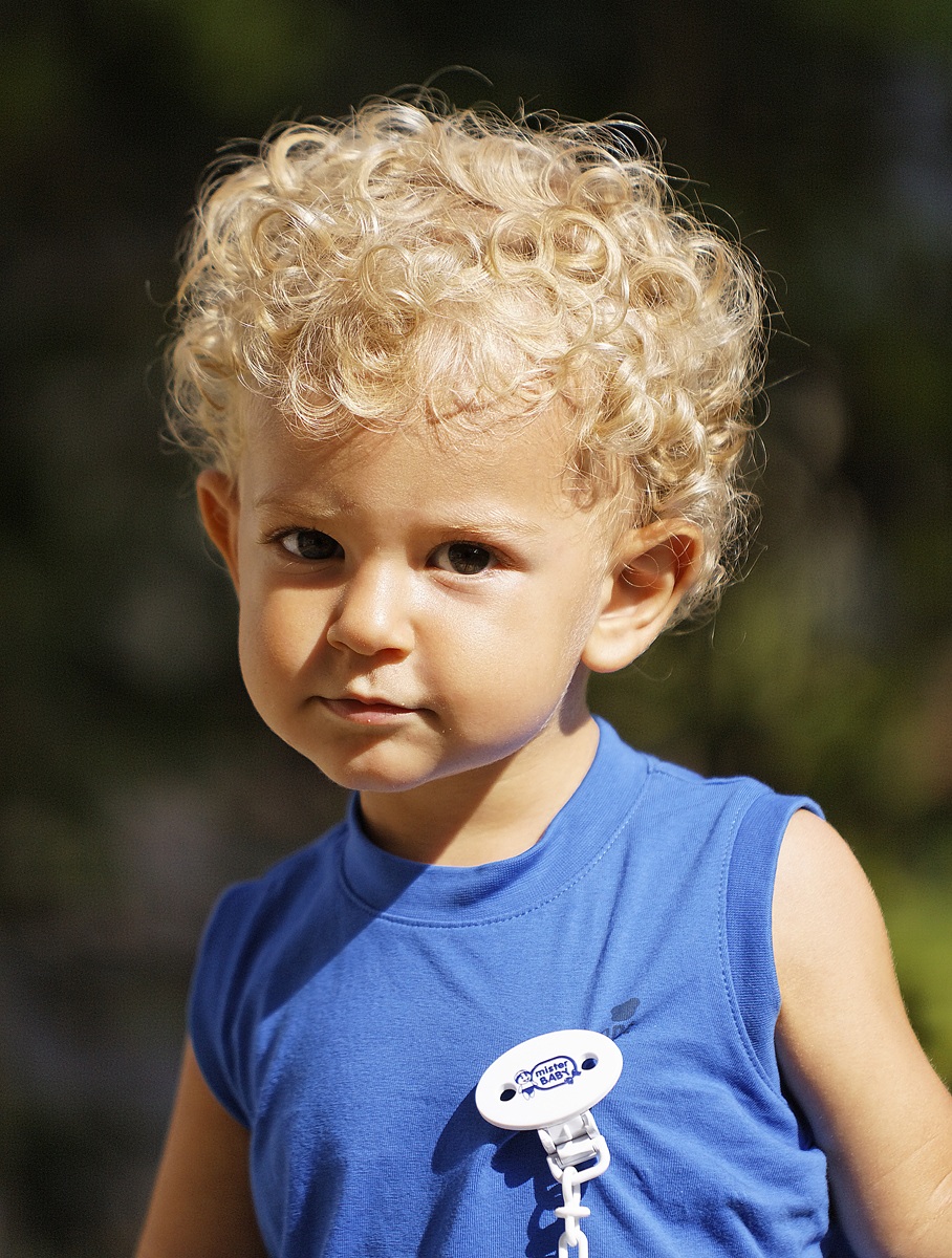 Blond boy with cunning eyes
