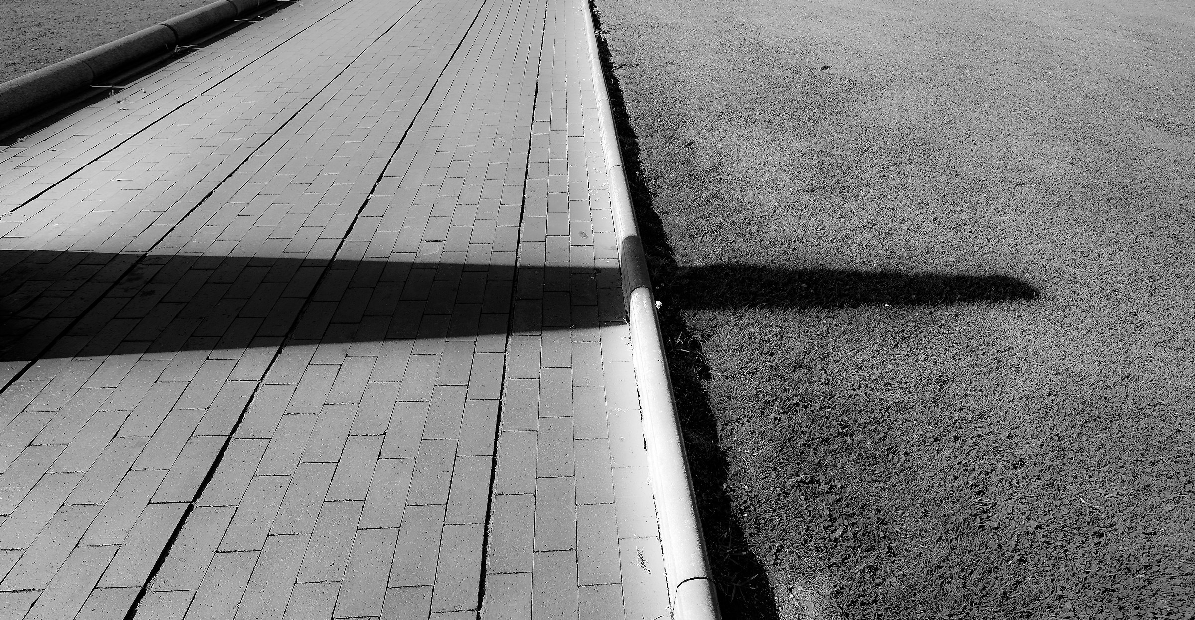 The relentless shadow walk past 'the curb ...
