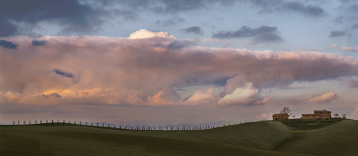 farmhouse with cypresses