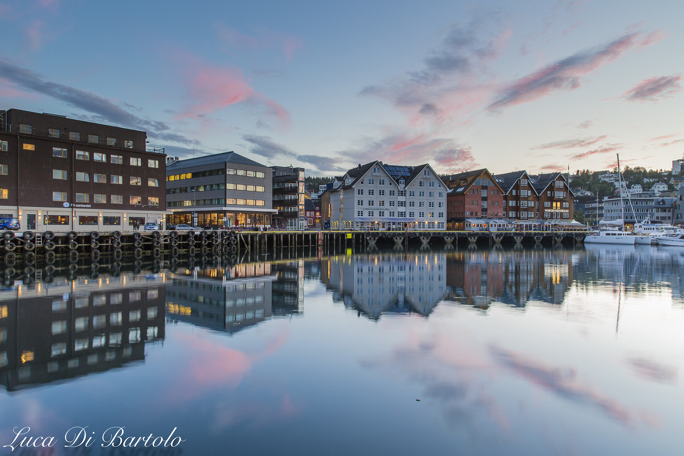 Troms (Norway) houses that are reflected at sunset