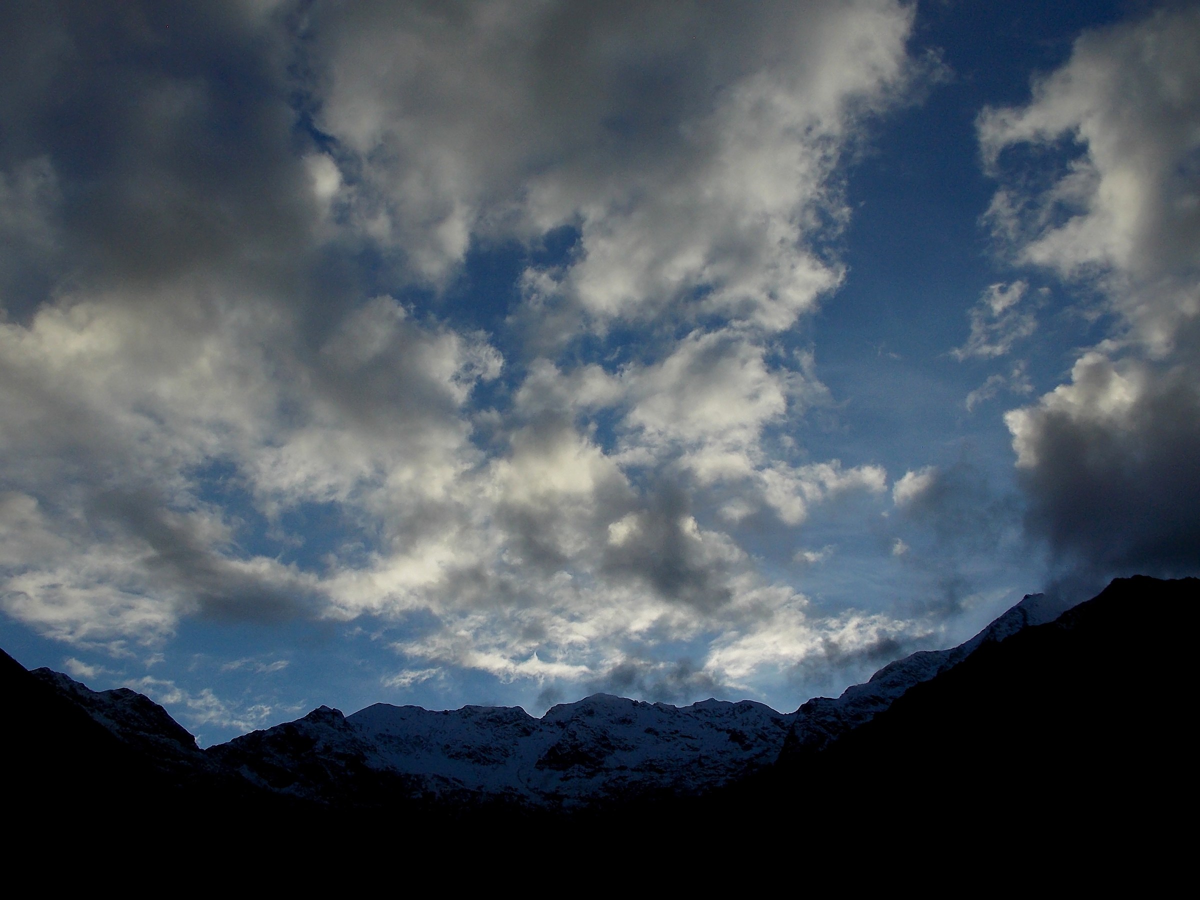 Clouds in the evening after the first snowfall of autumn