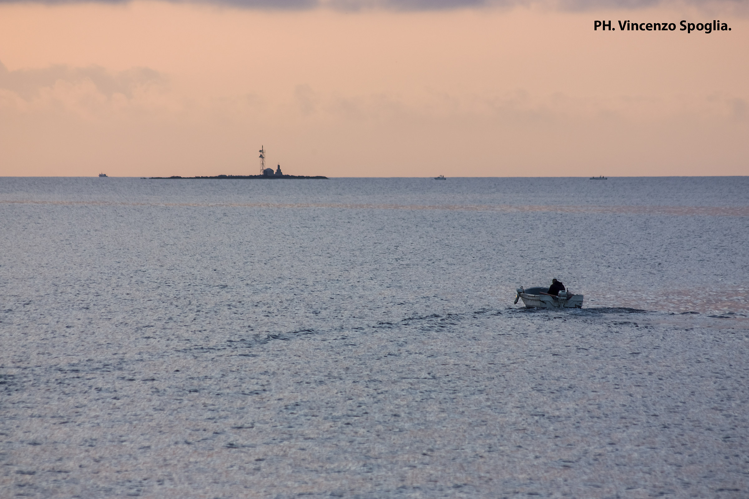 Boat traveling at sunset
