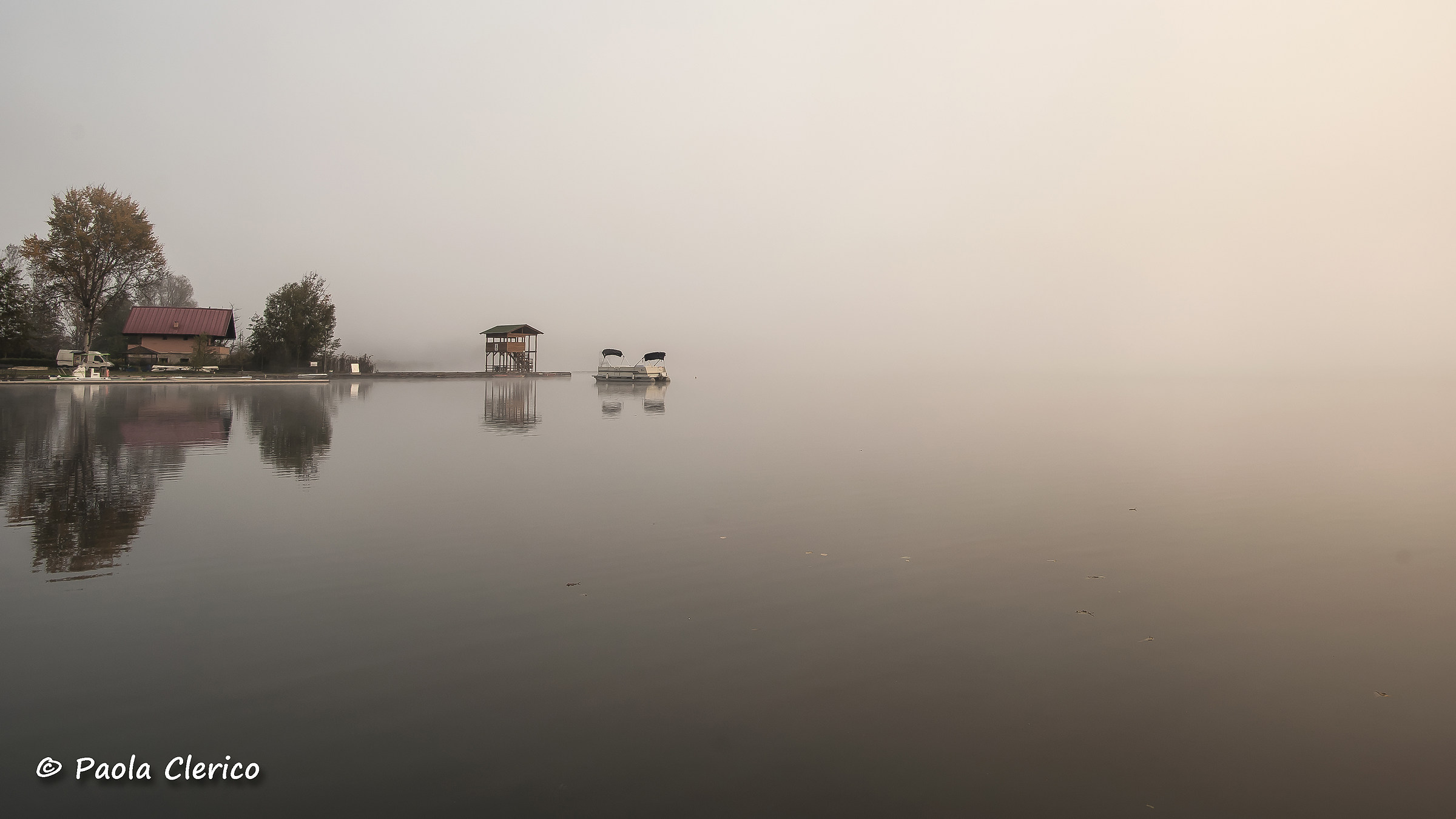 Sunrise in the fog on the lake
