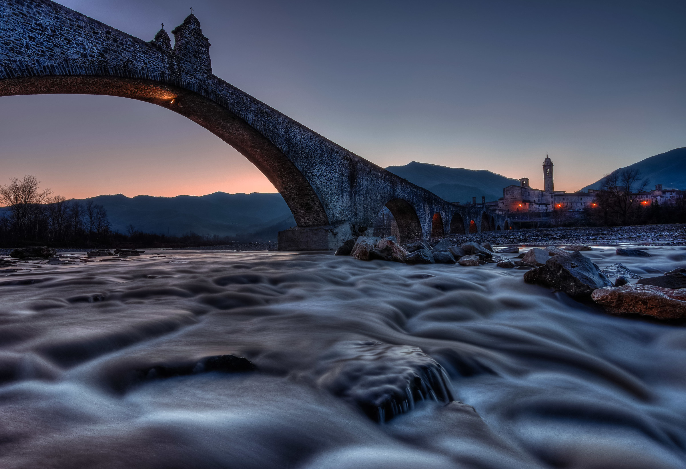 Bobbio, humpbacked bridge after sunset ...