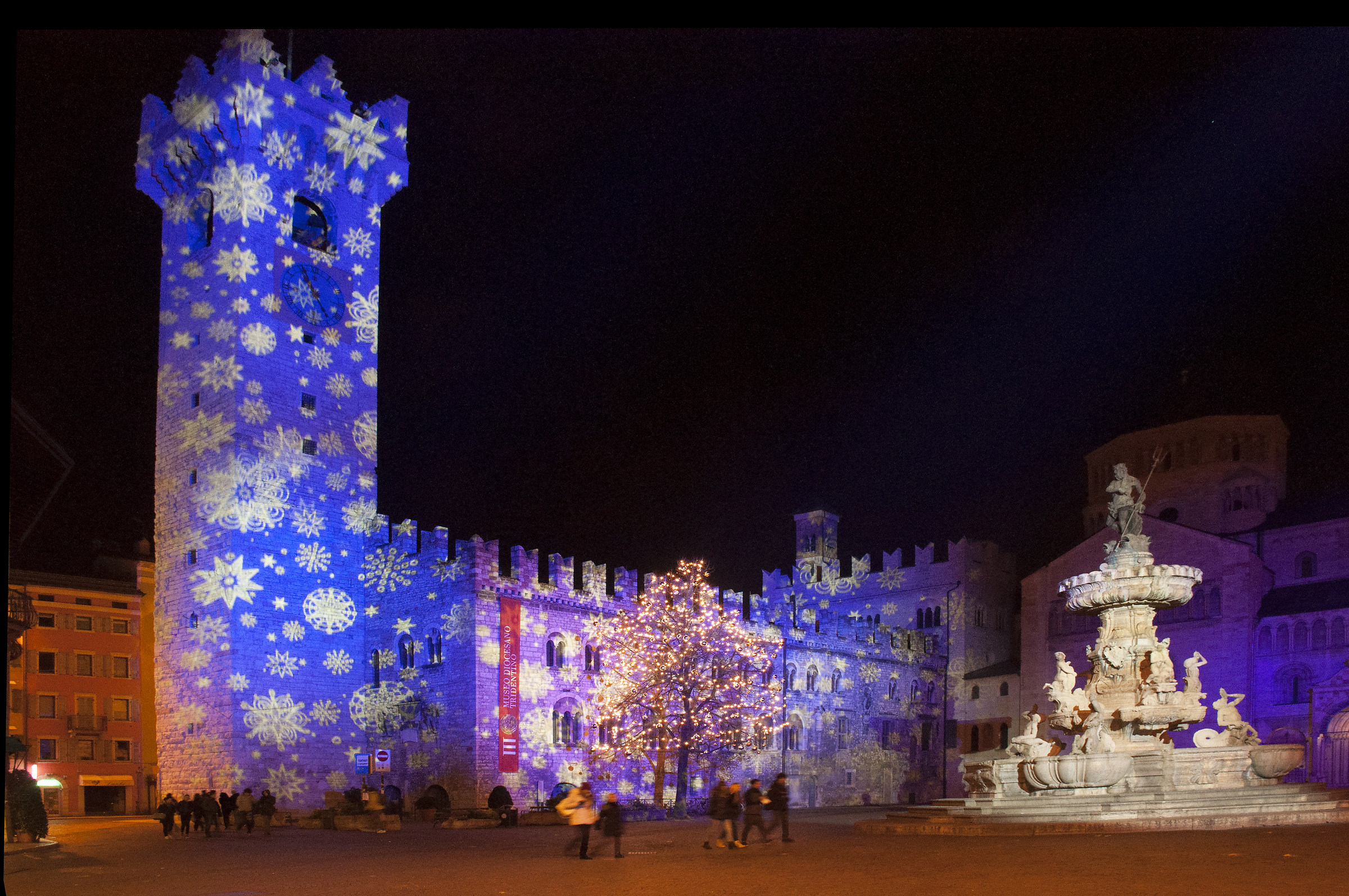 Christmas in Piazza Duomo in Trento. Civic Tower