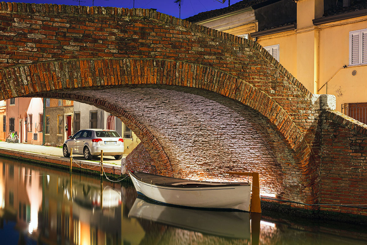 A bridge a car a boat and a bike
