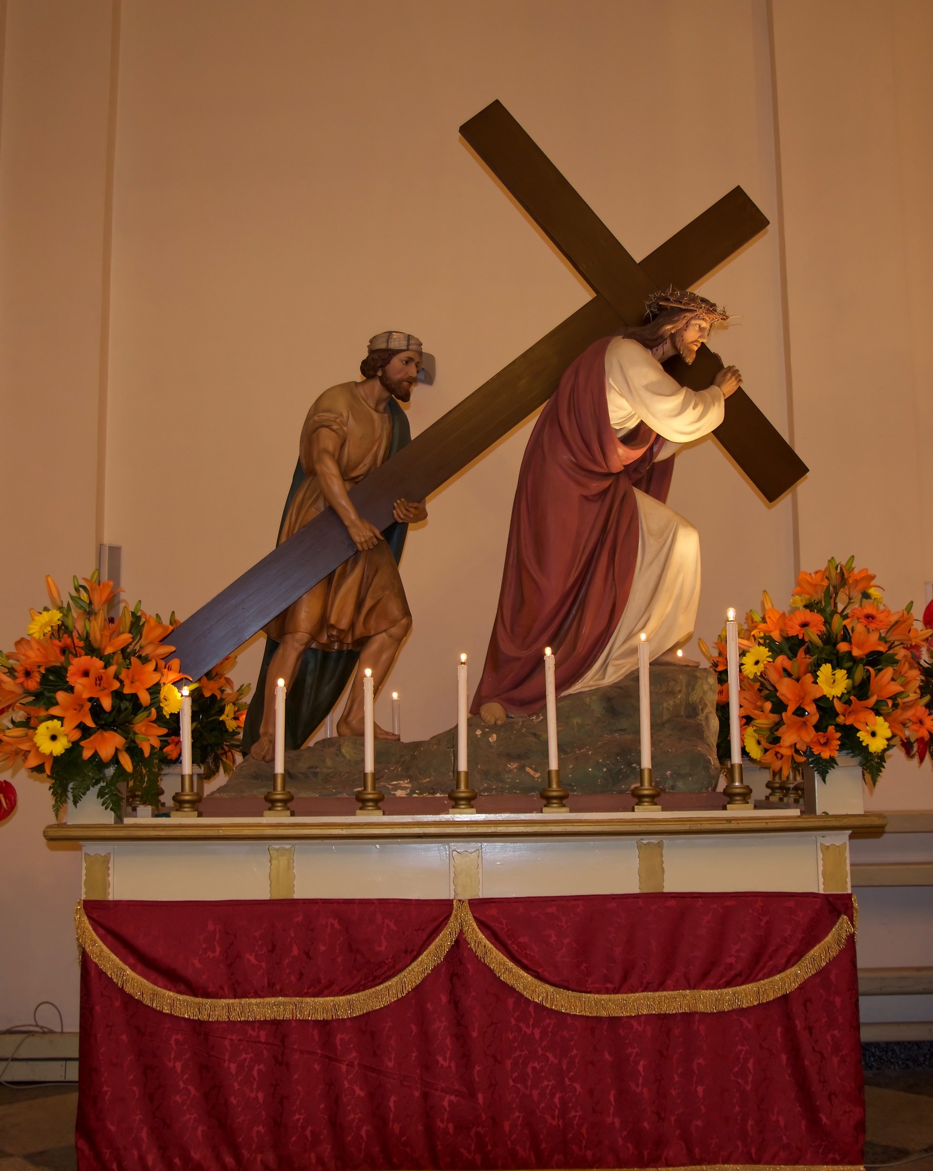 Simon of Cyrene helps Christ to carry his cross