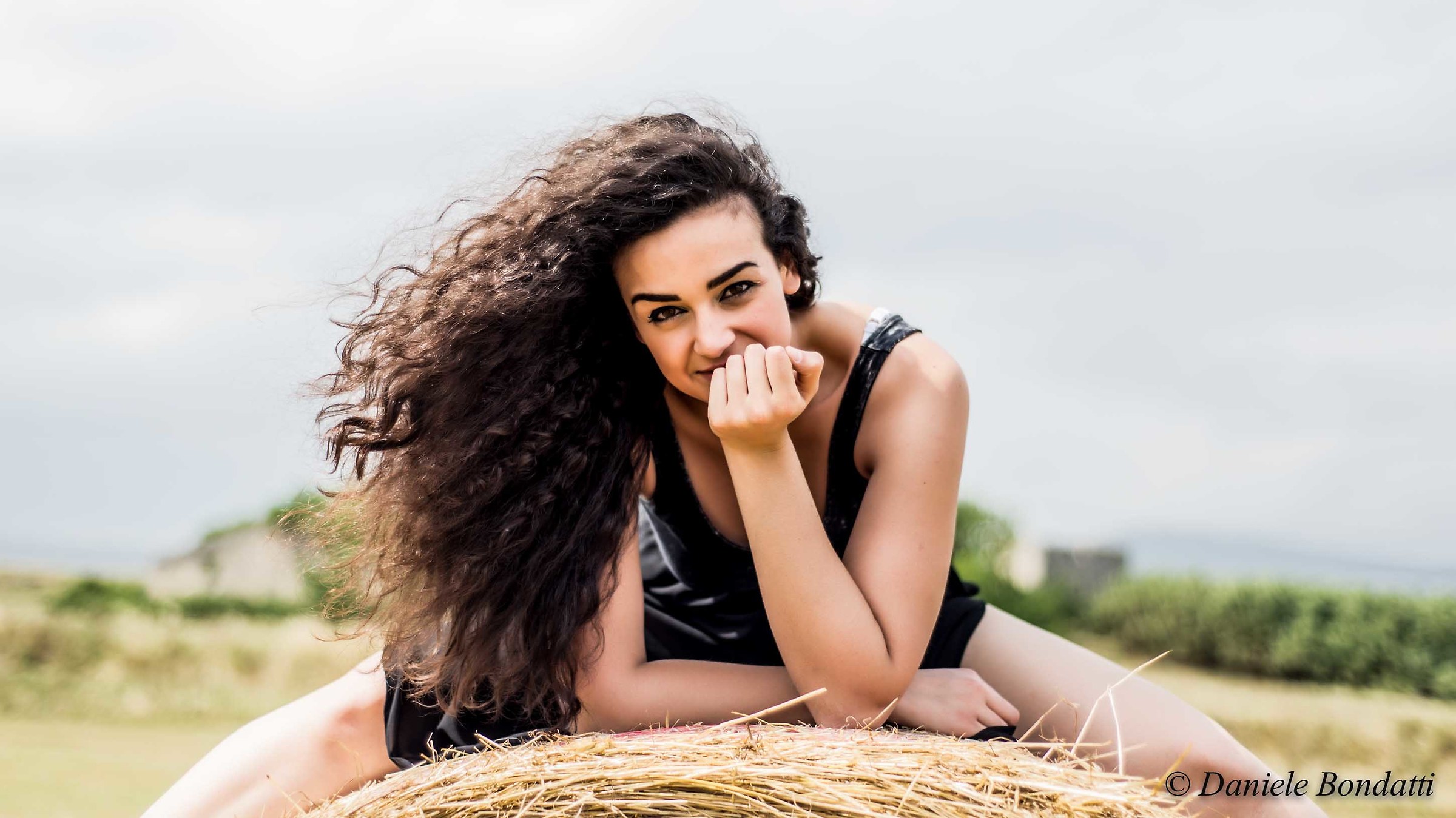 between the bales of hay