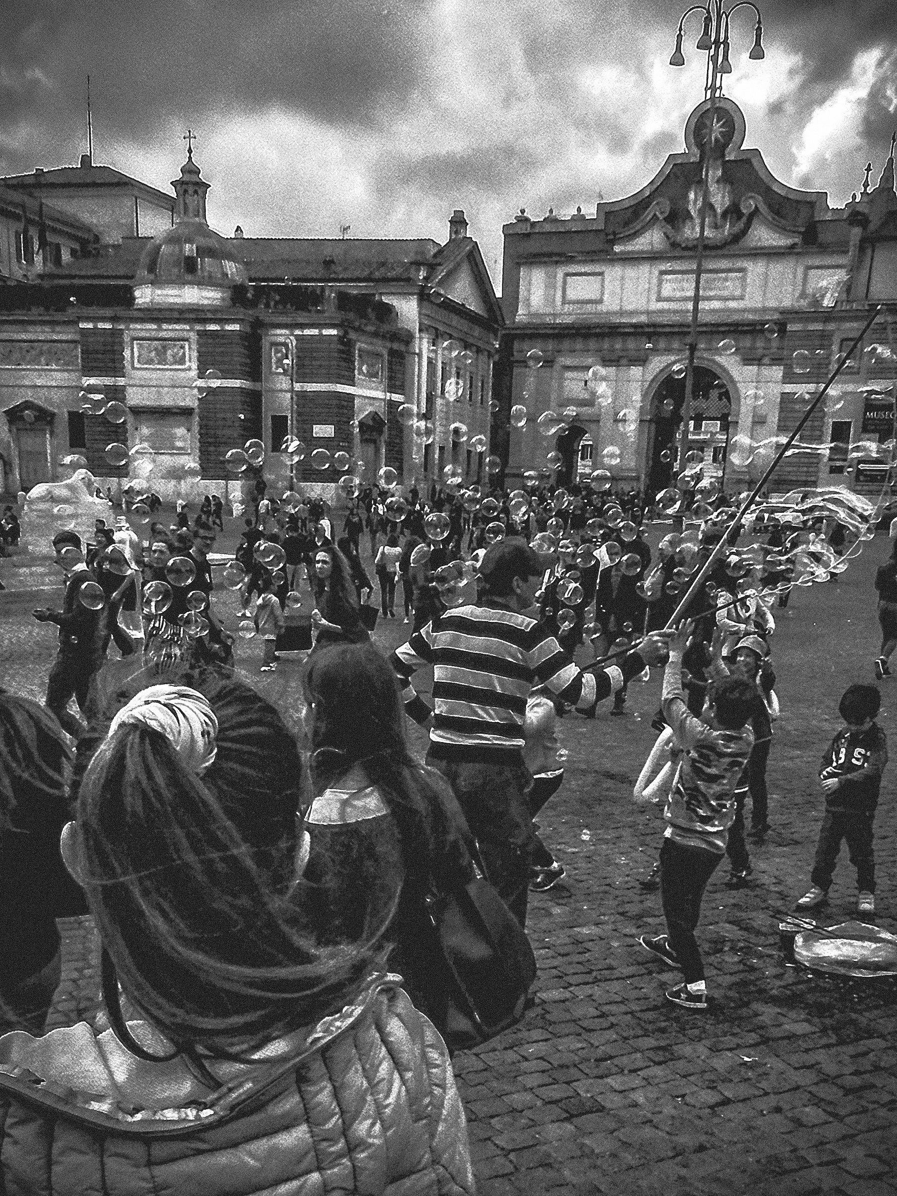 Children and bubbles in the square in Rome Bw