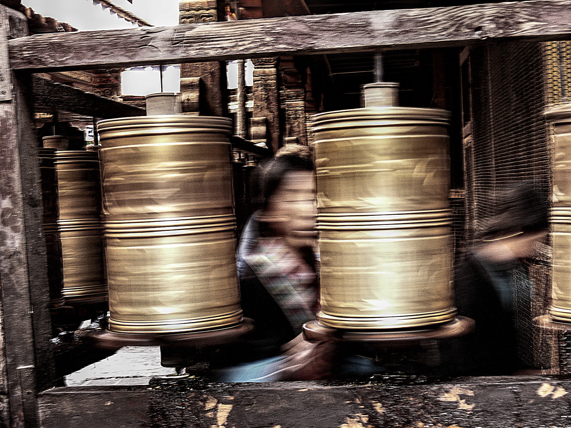 Faithful turn the prayer rolls in a monastery