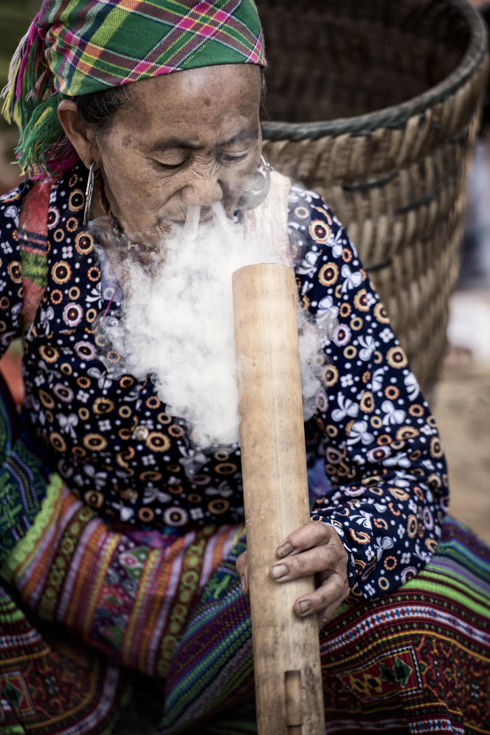 Smoking the typical water pipe (thuoc Lao)