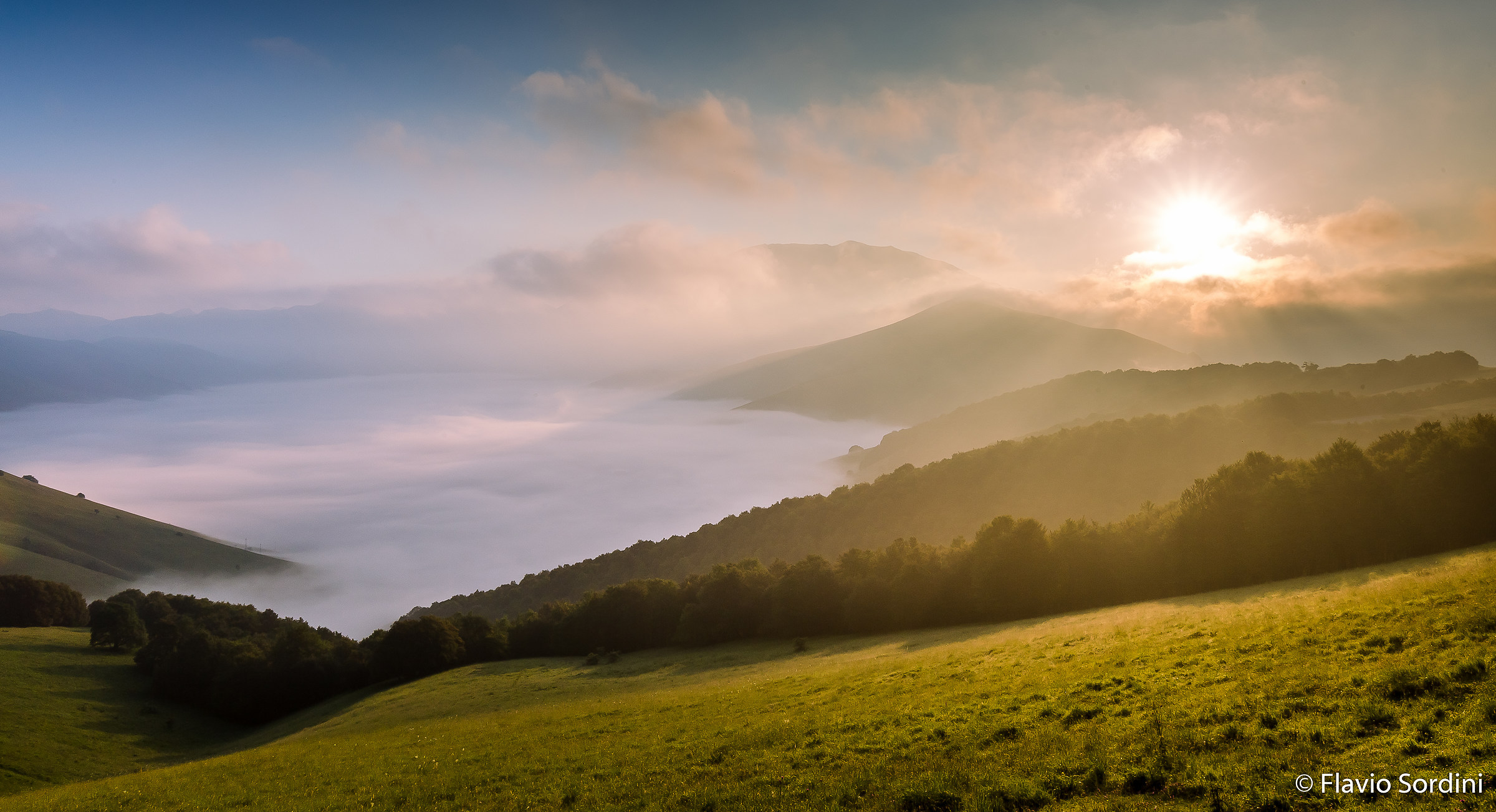 Alba between clouds and fog