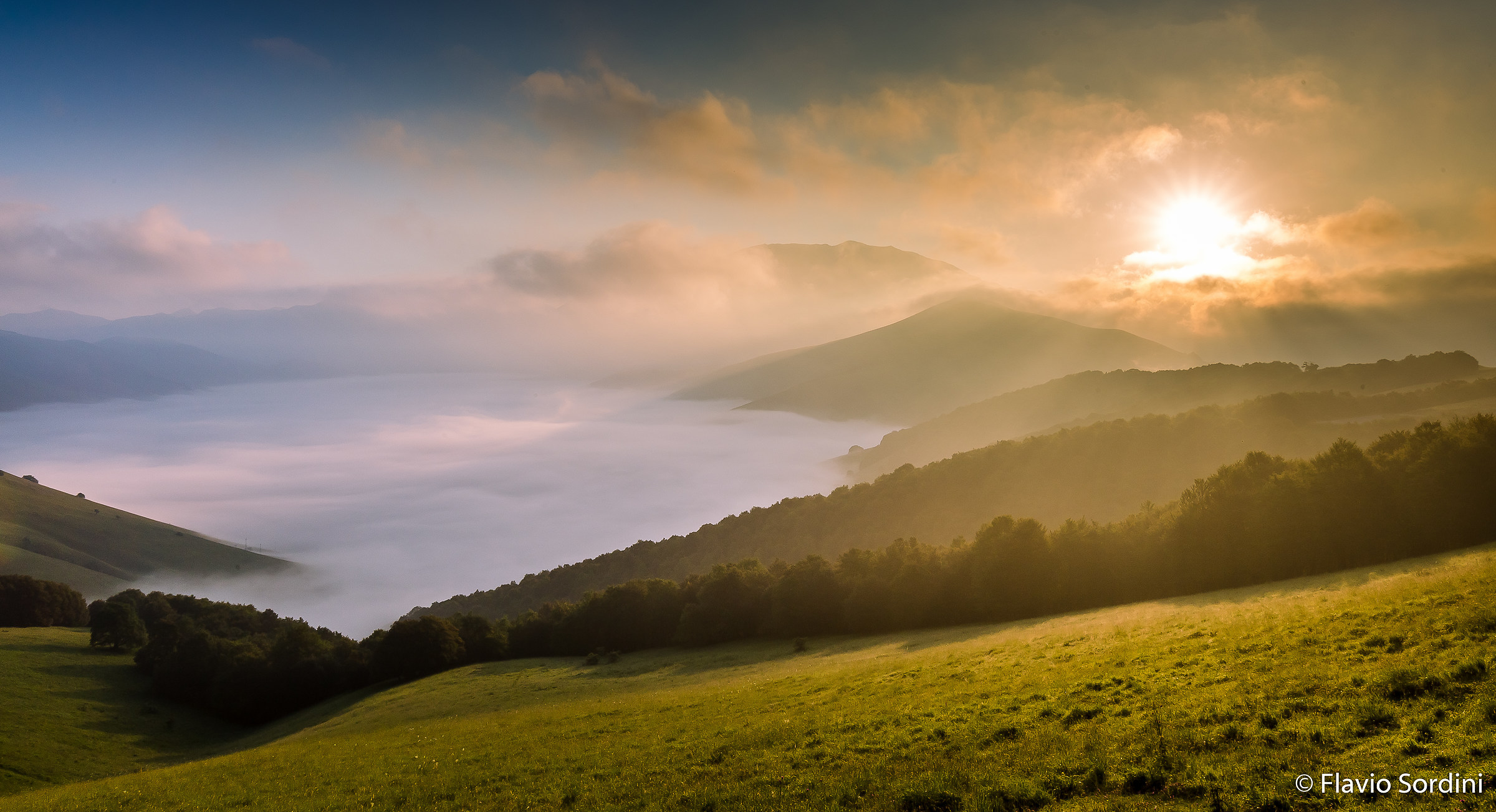 Alba between clouds and fog