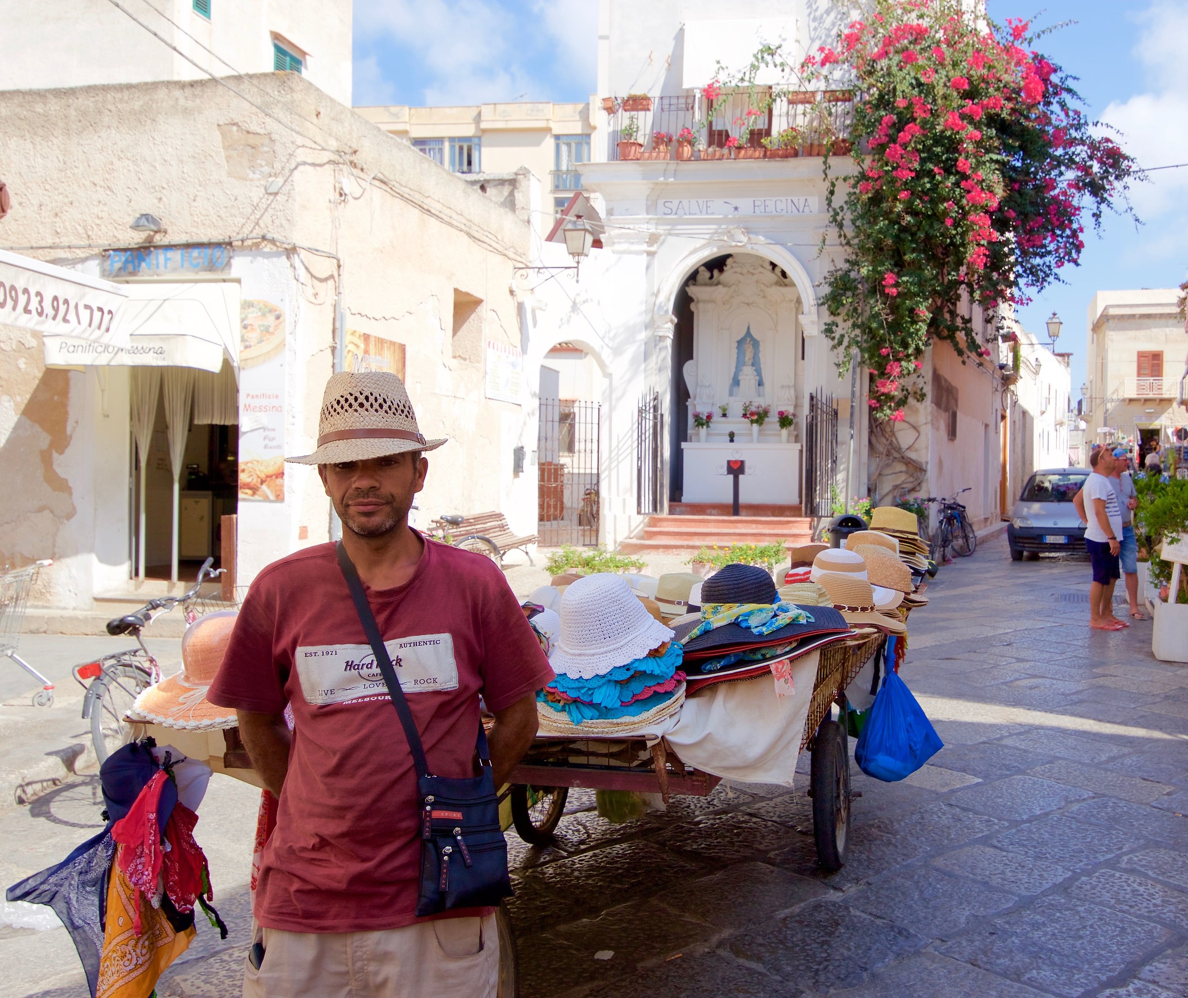 Hats in front of the newsstand votive