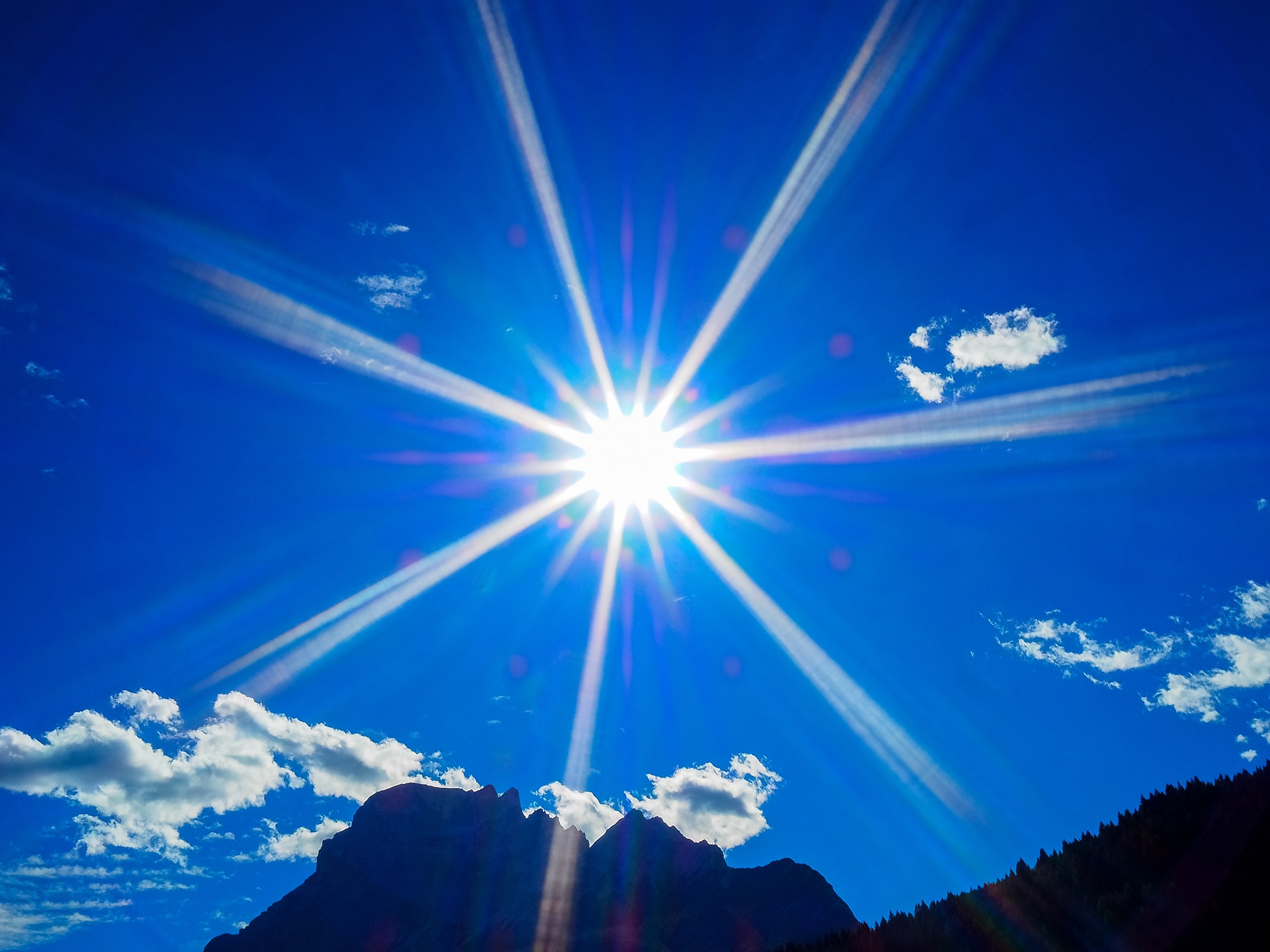 The sun shines in the sky