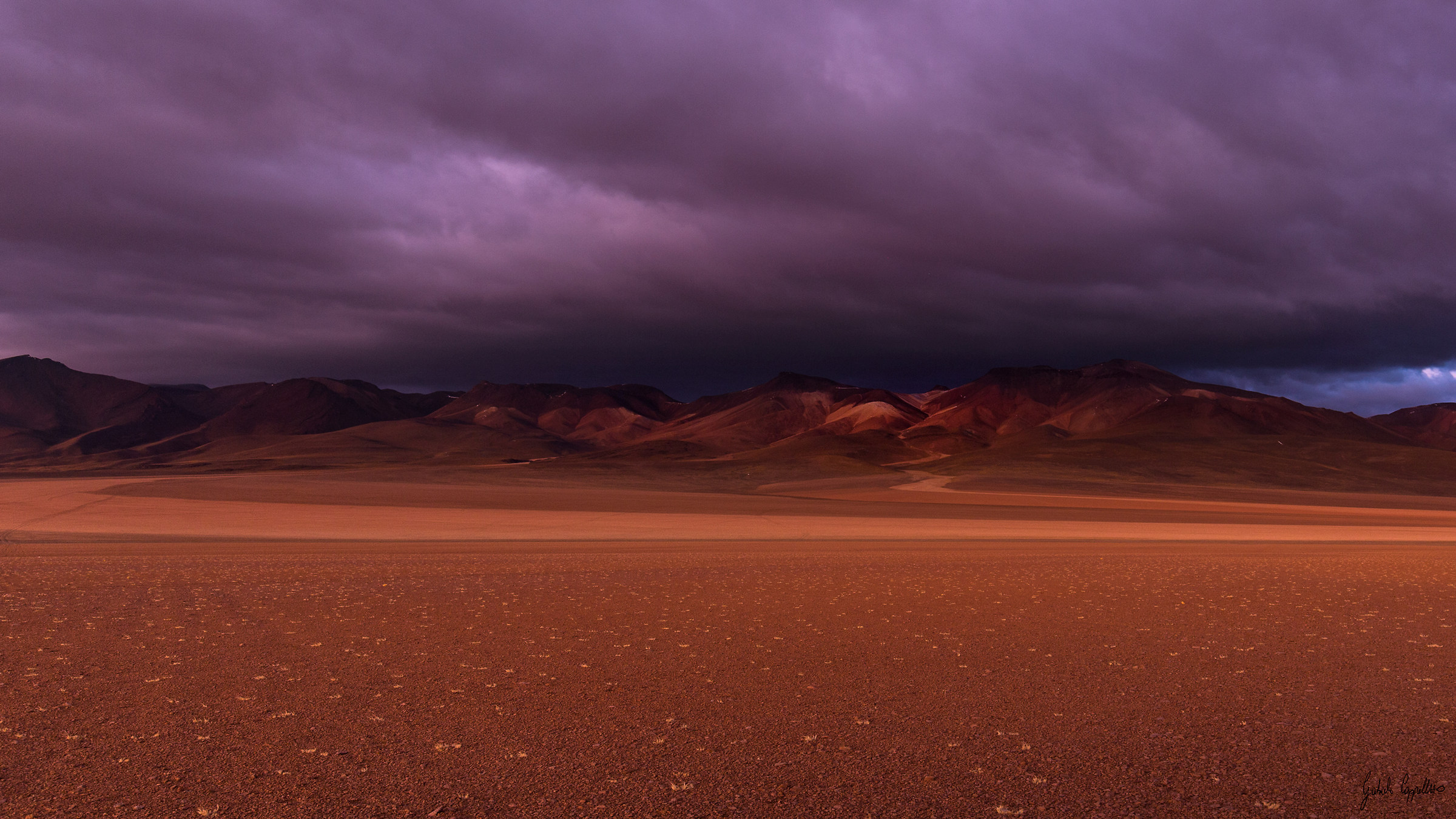 The first lights color the desert