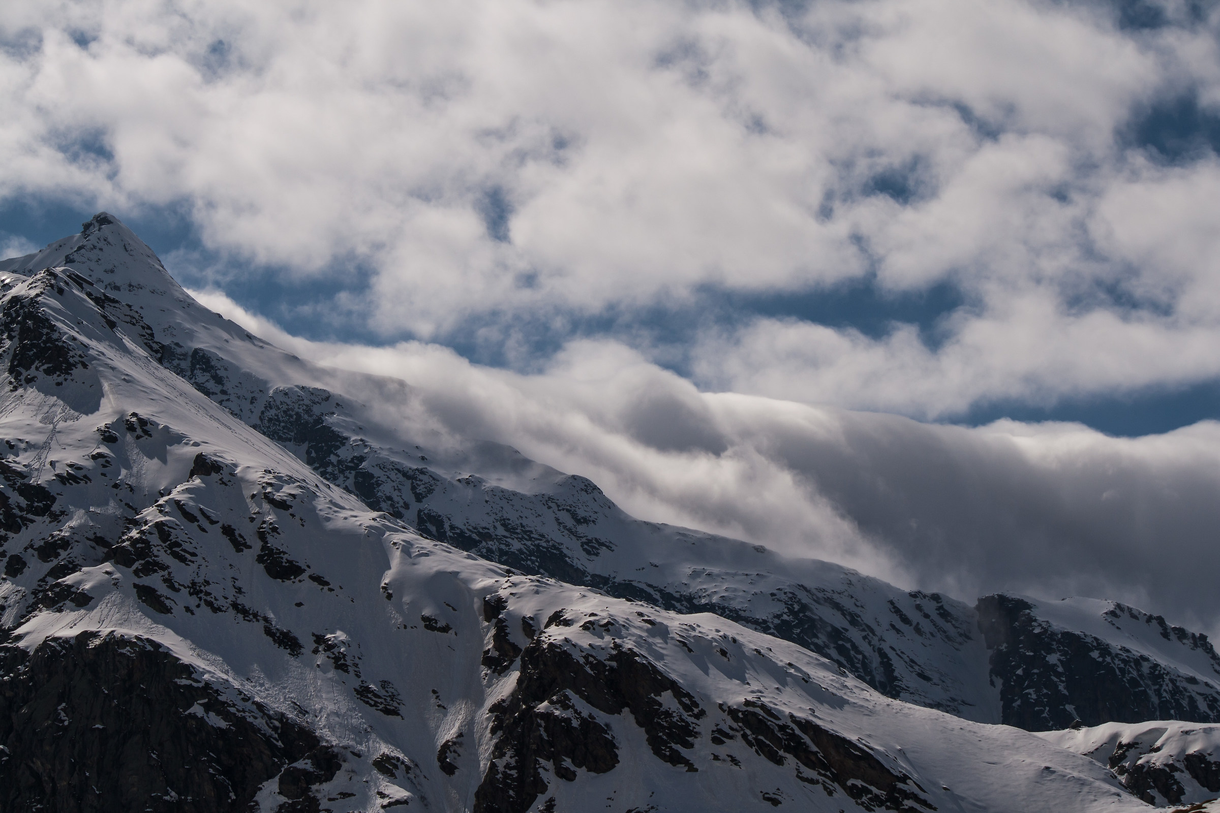 the clouds pass over the mountains by the wind