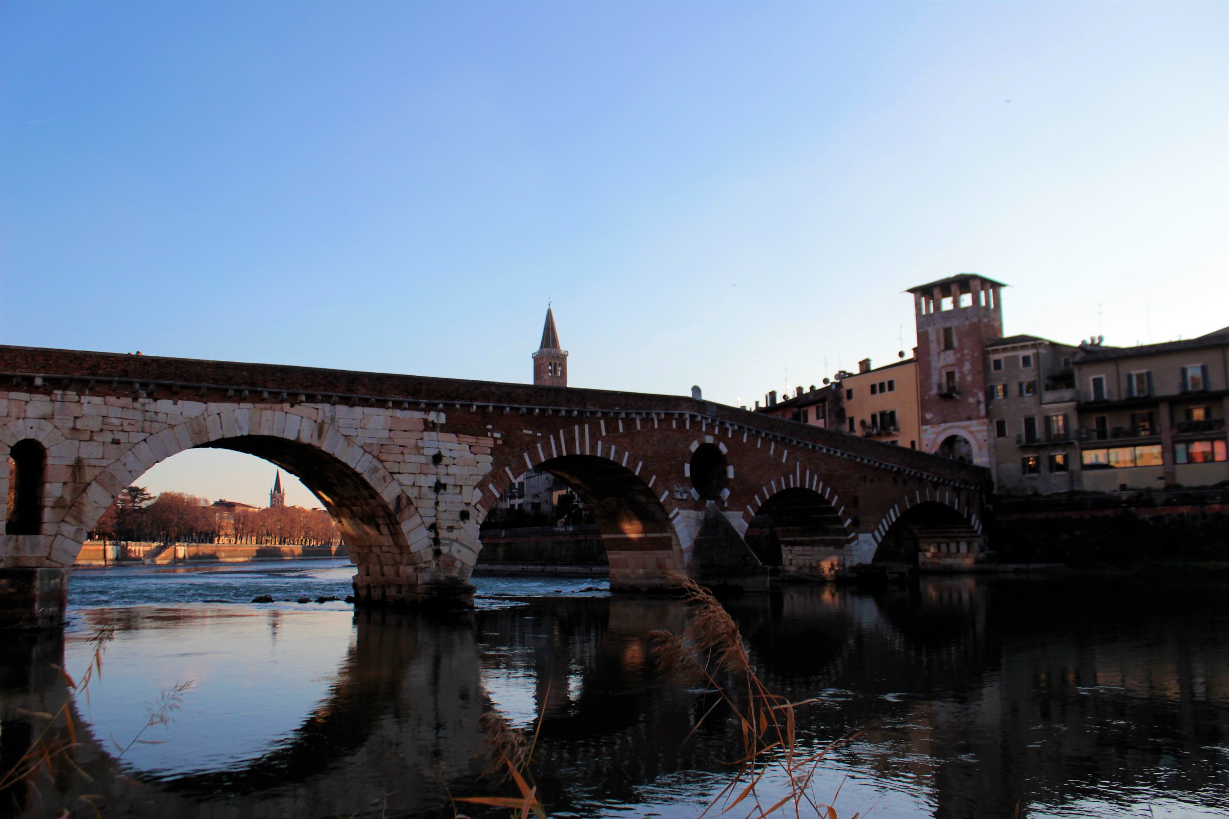 The Adige reflects the Stone Bridge