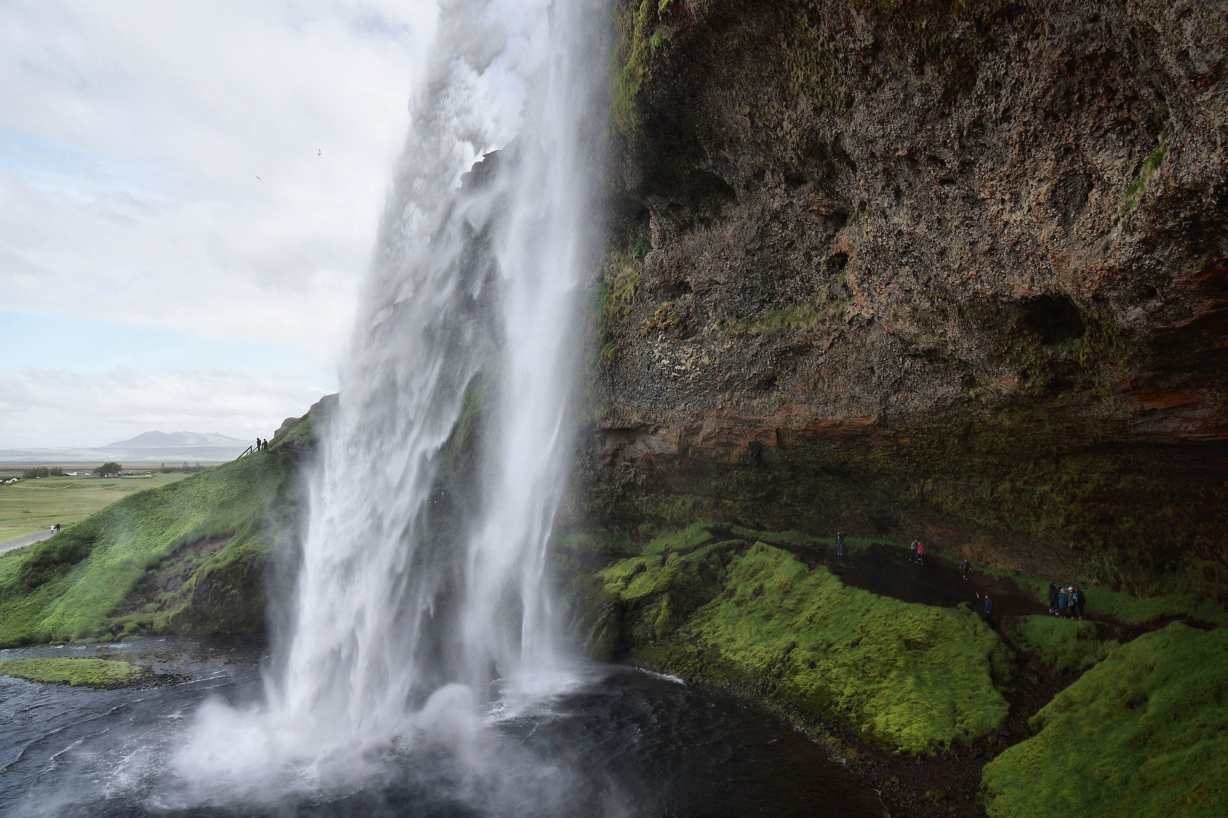 Under the waterfall.