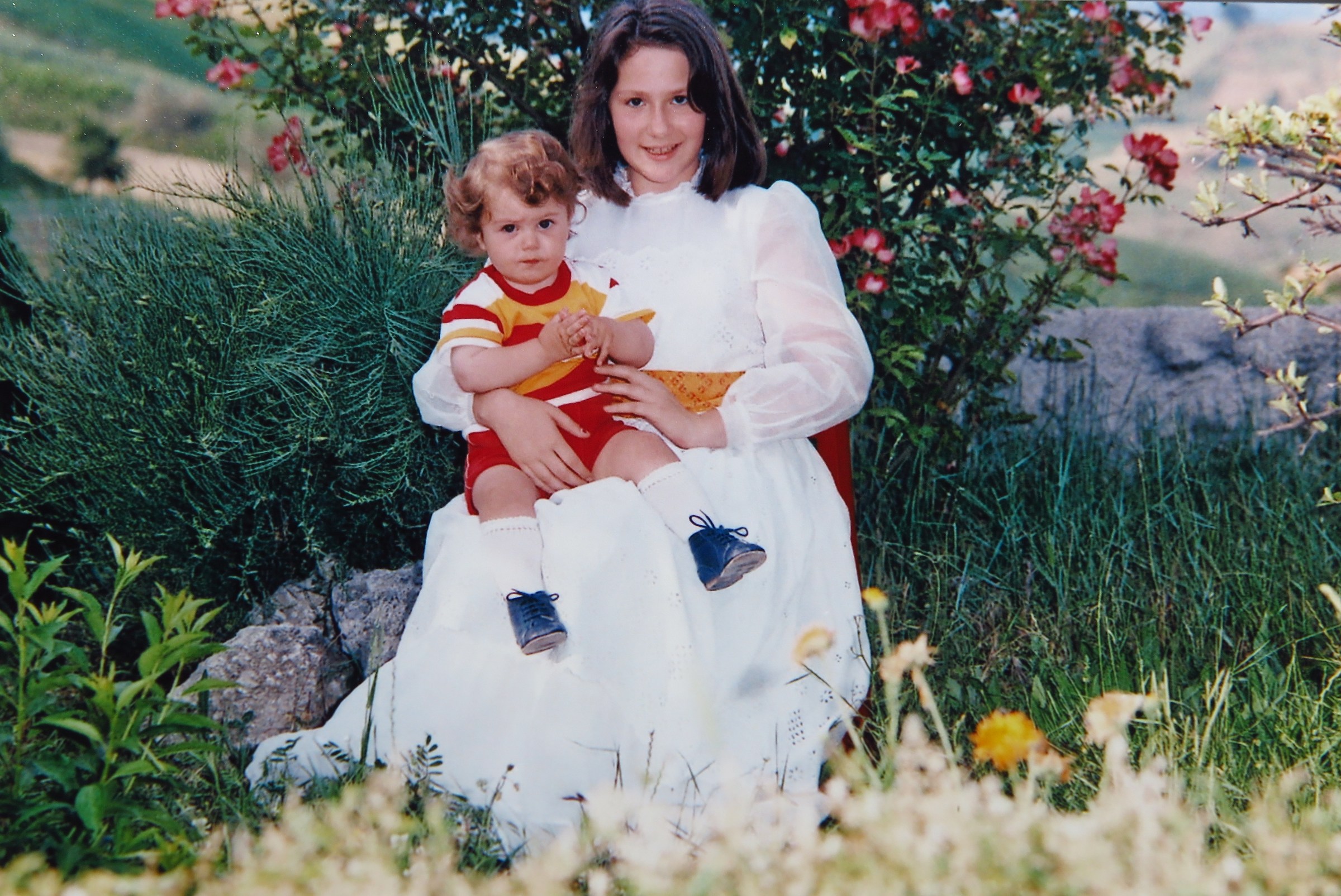 Young girl in flower with baby.