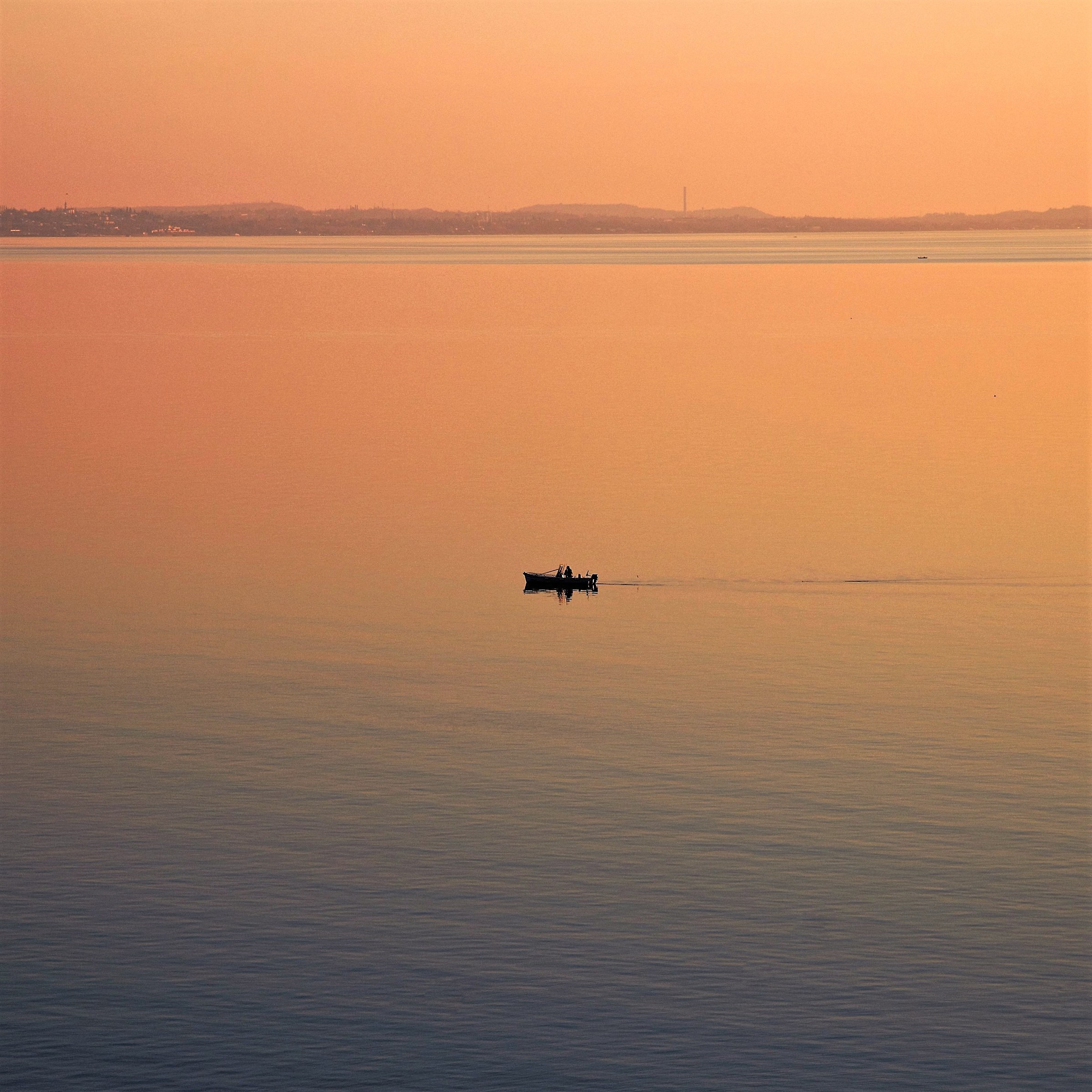 Only a fisherman with his boat at sunset