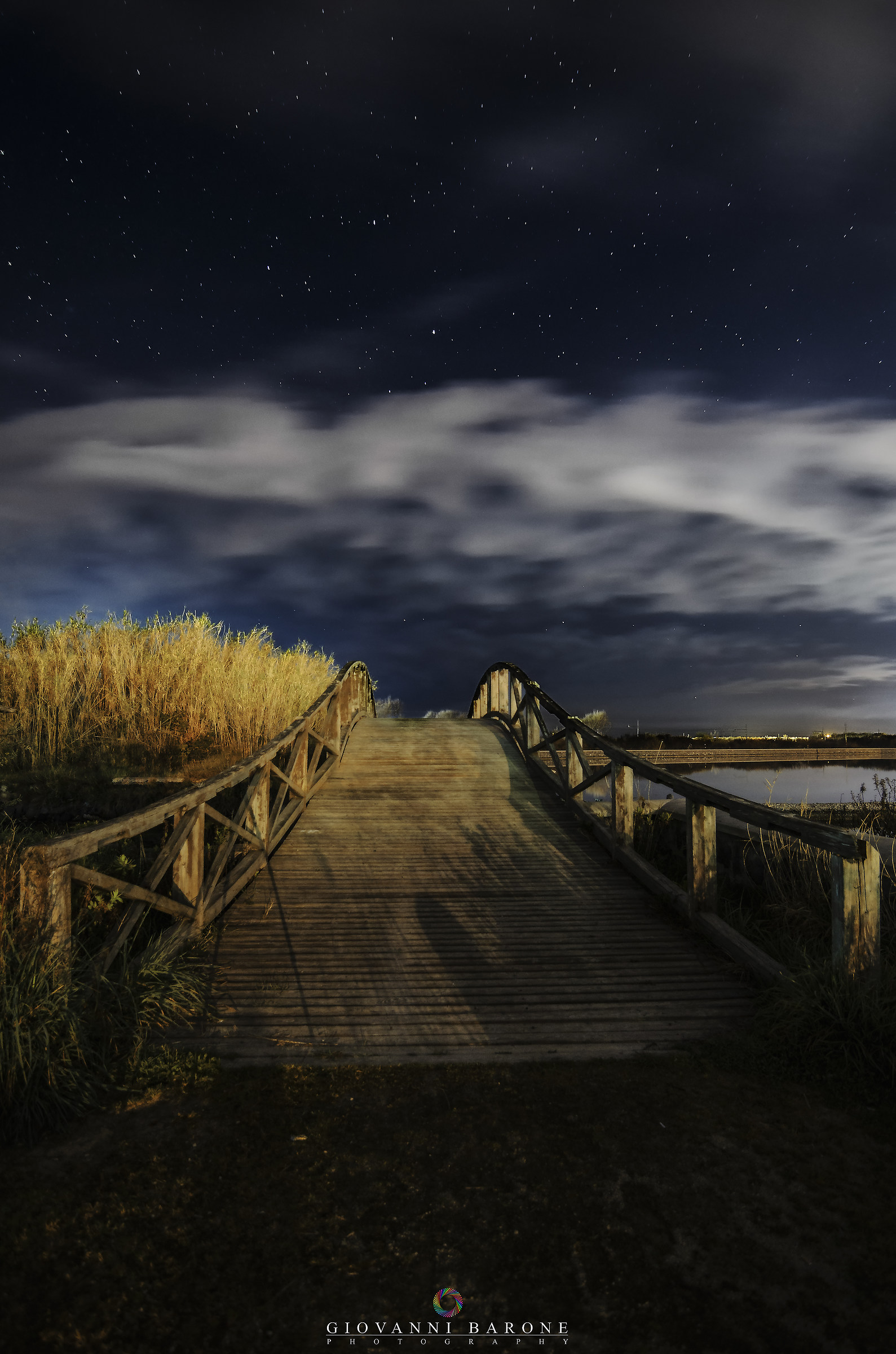 Bridge on the lake on a starry night