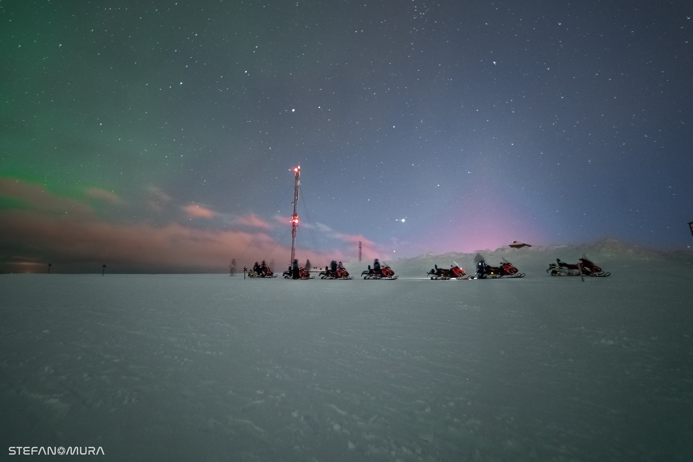 Snowbike safaris below Northern lights