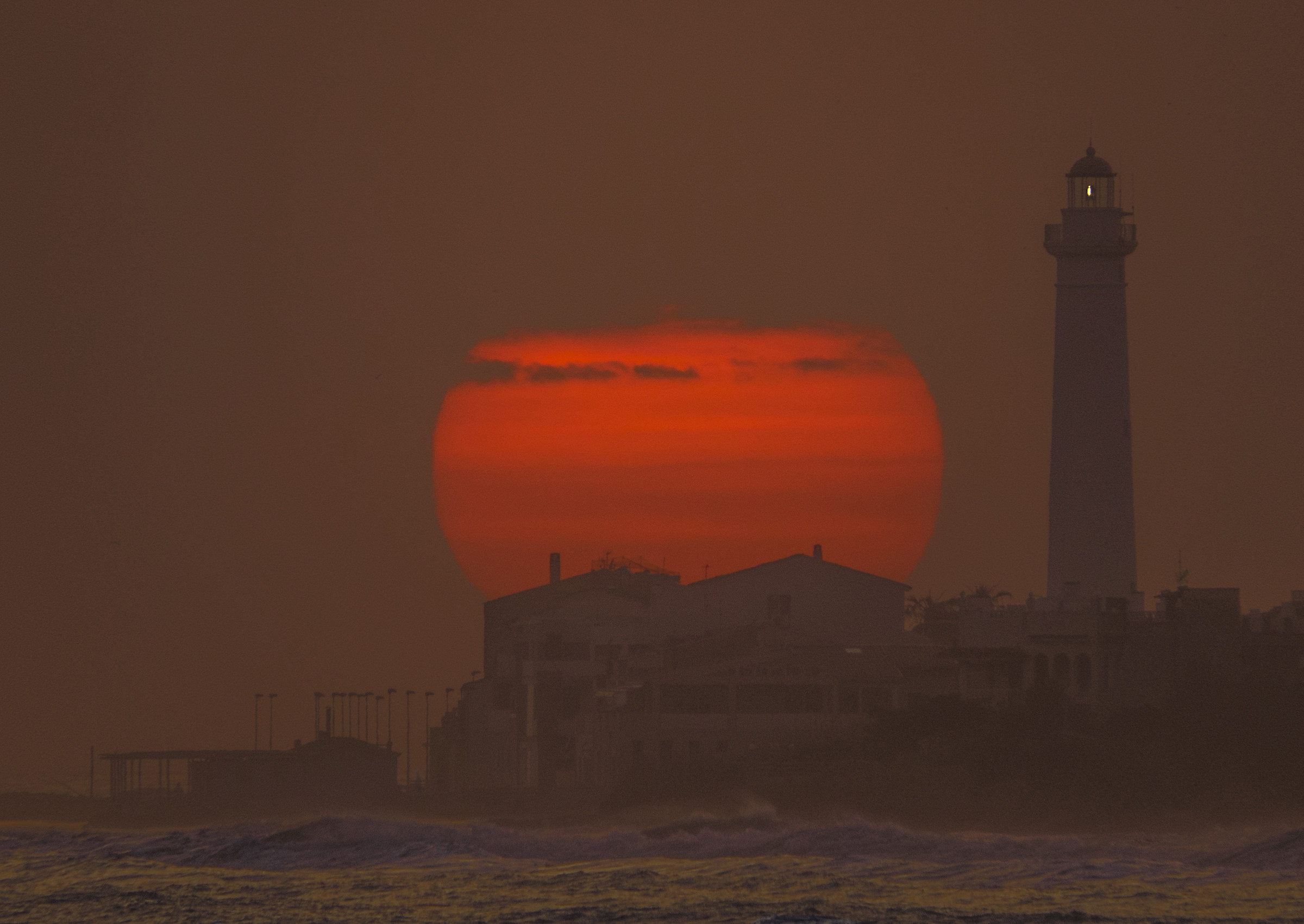 Sunset on the lighthouse of Punta Secca (Ragusa)