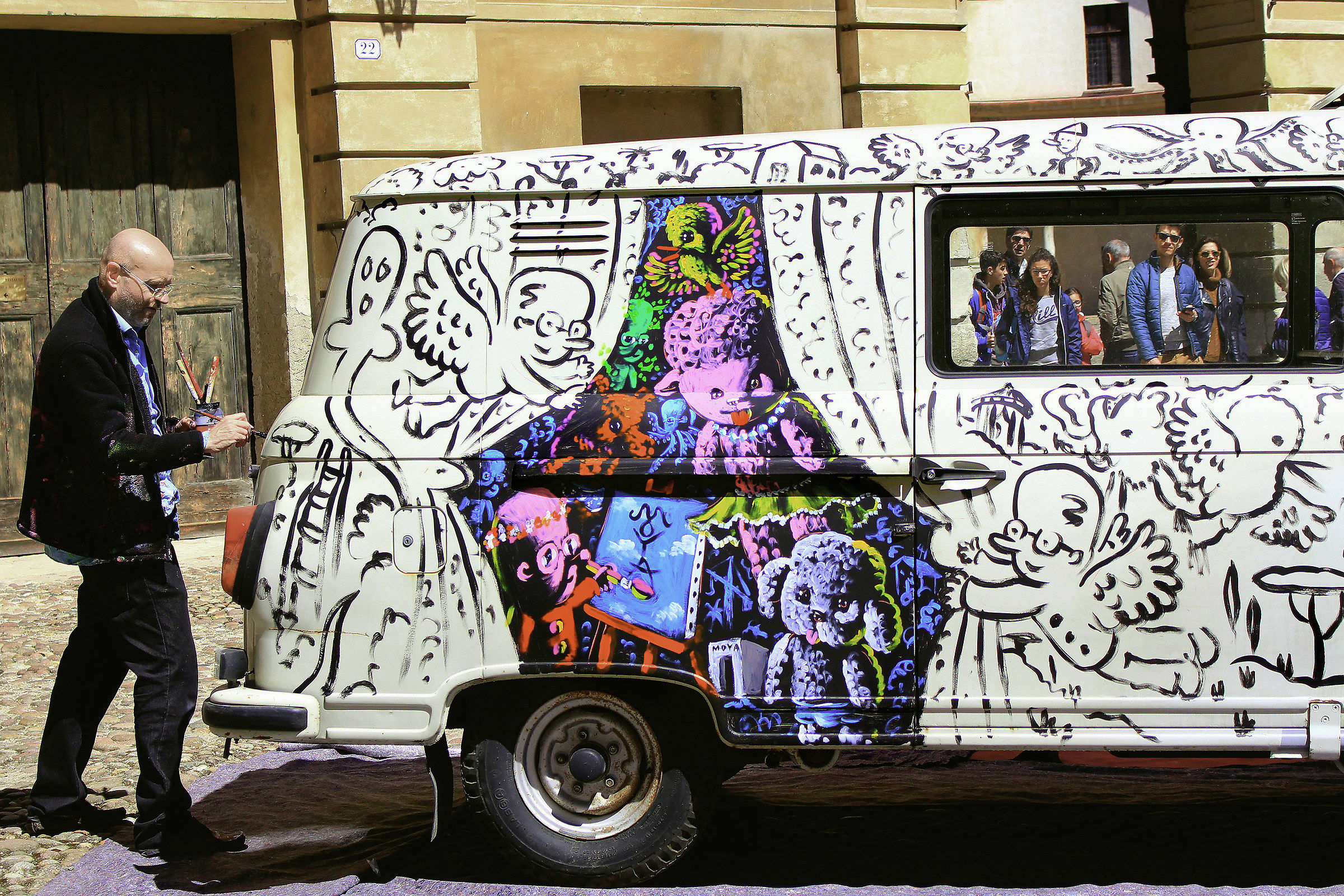 Painter at work with viewers