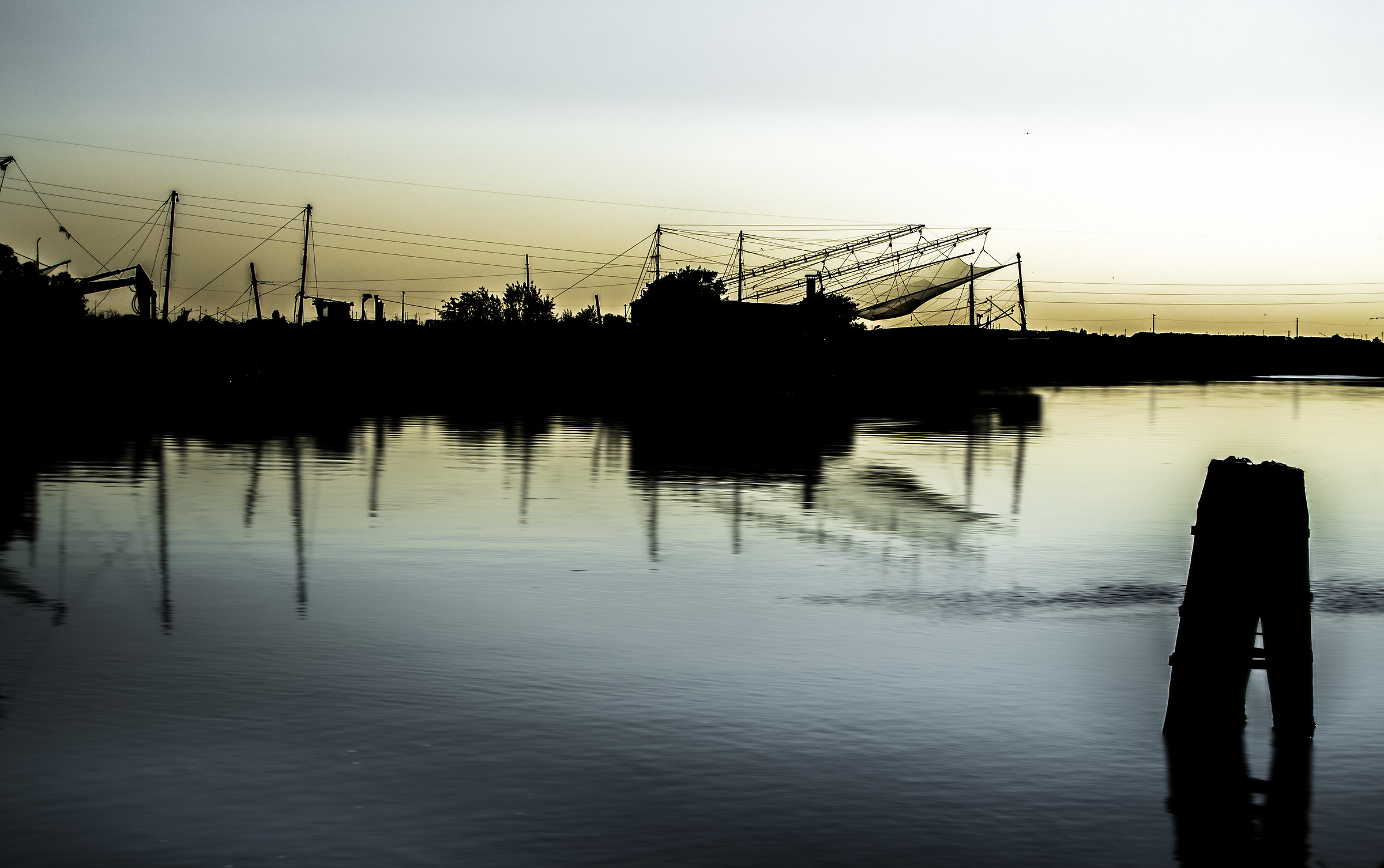 Silhouette of fishing huts at sunset