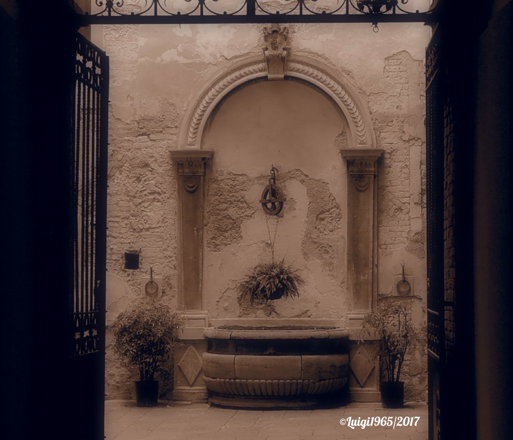 In a doorway of San Quirico D'Orcia.