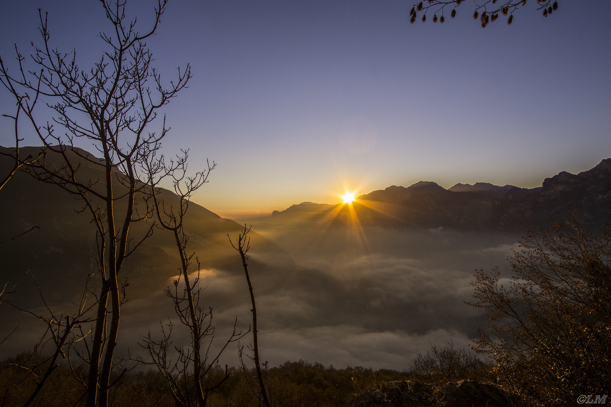 Sunset over Lake Garda covered by fog