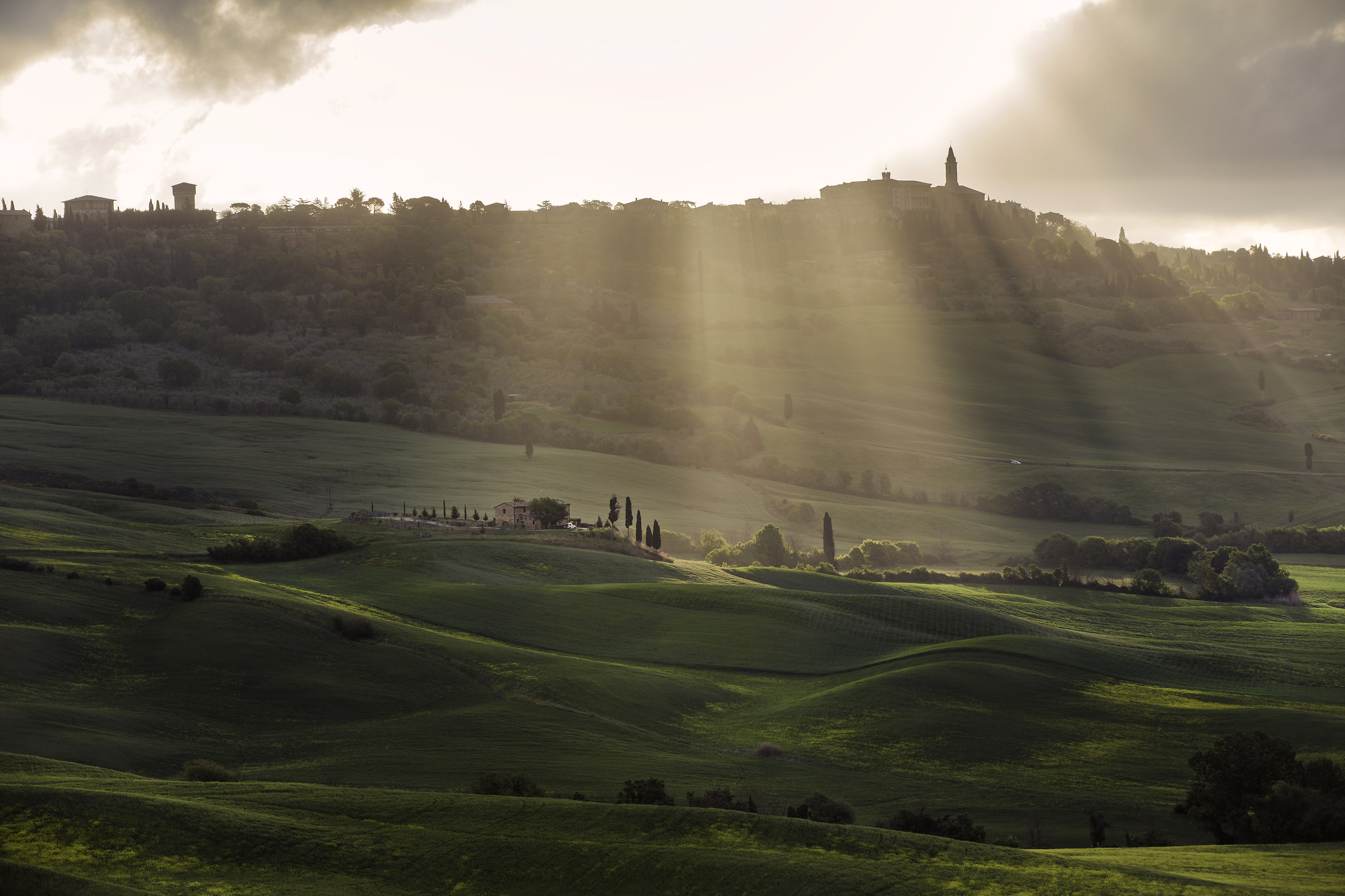 Sun rays in Val d'Orcia after dawn