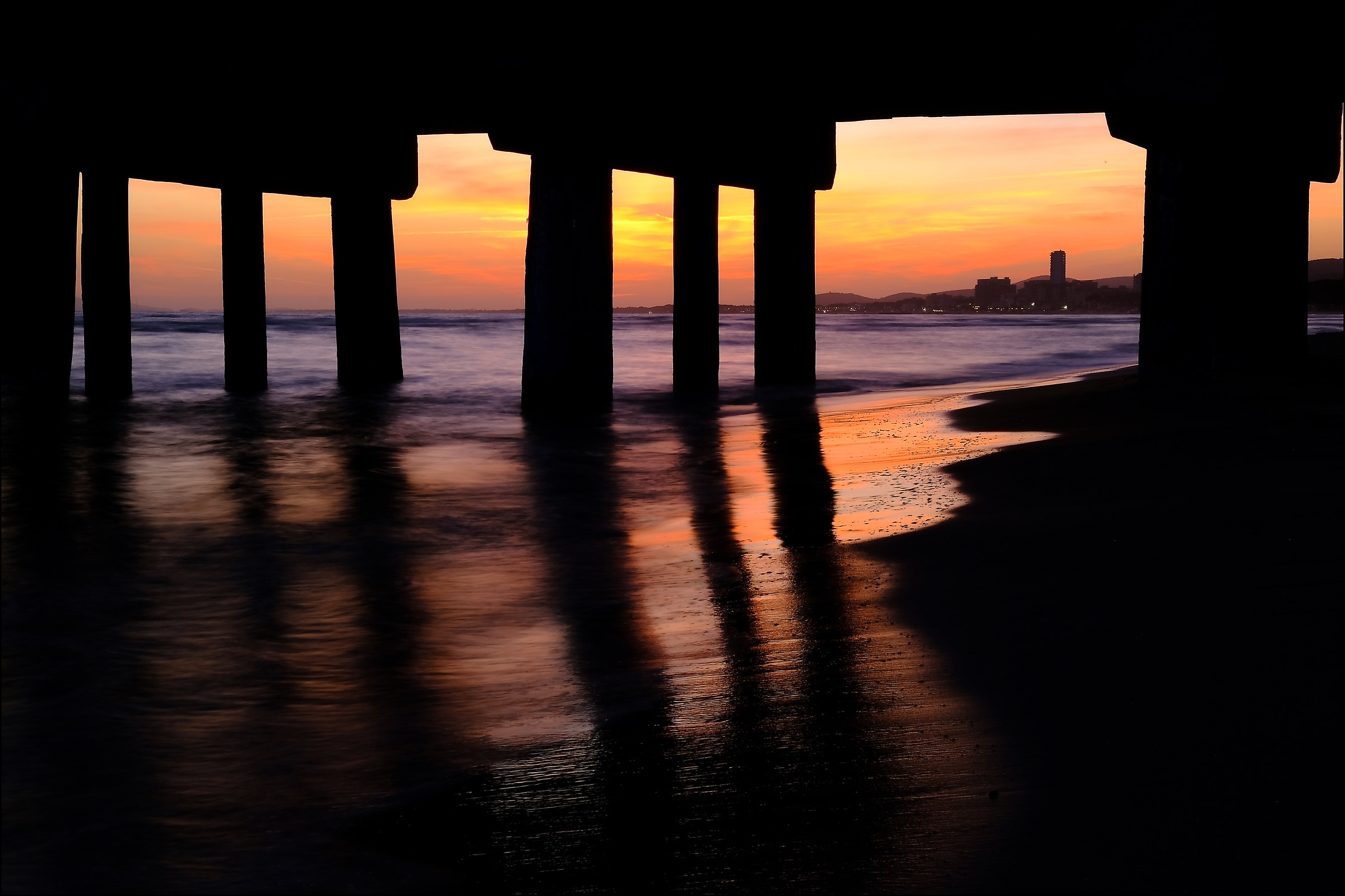 Sunset over Follonica by the dock
