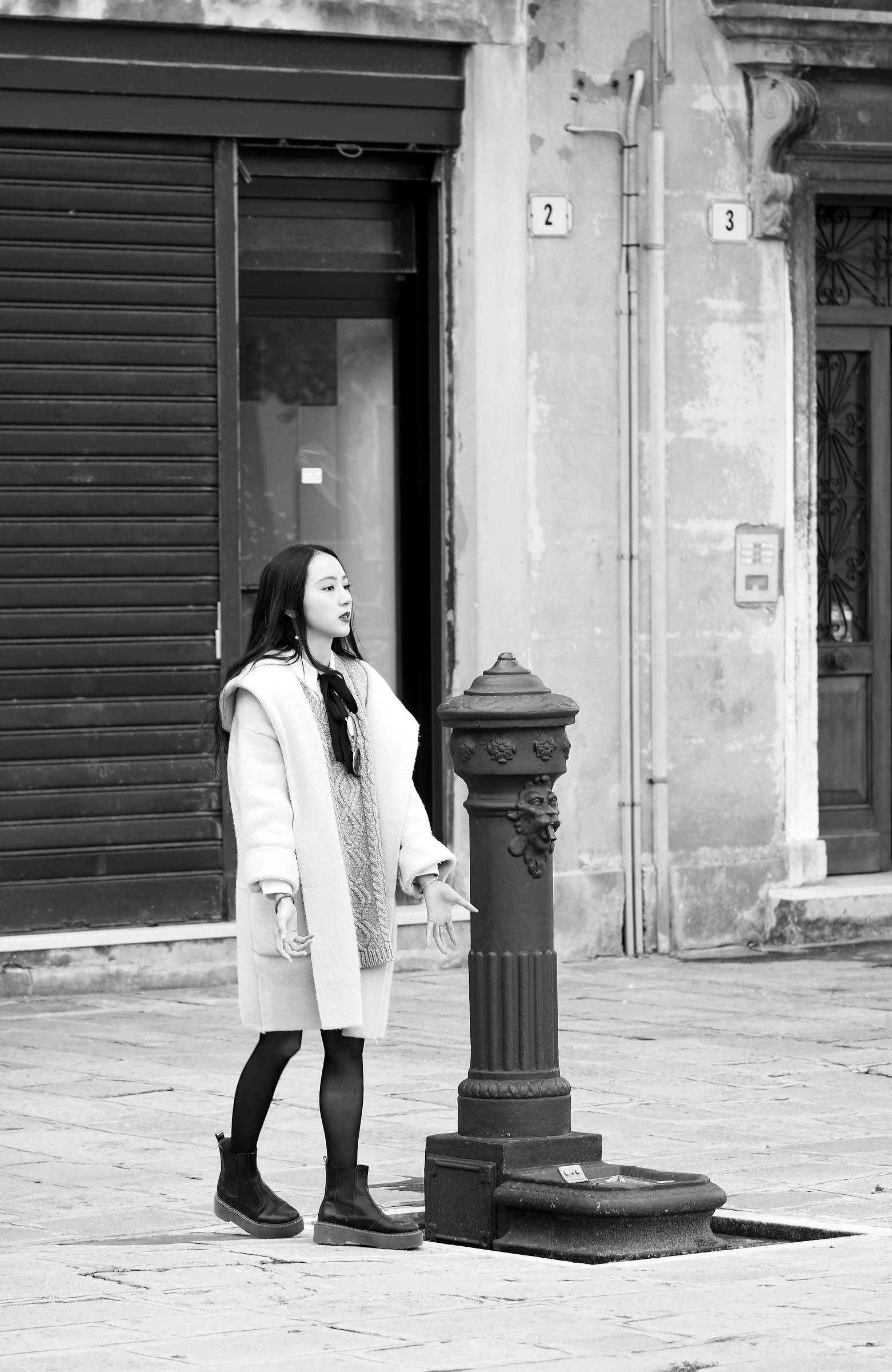 Young japanese at the fountain without water