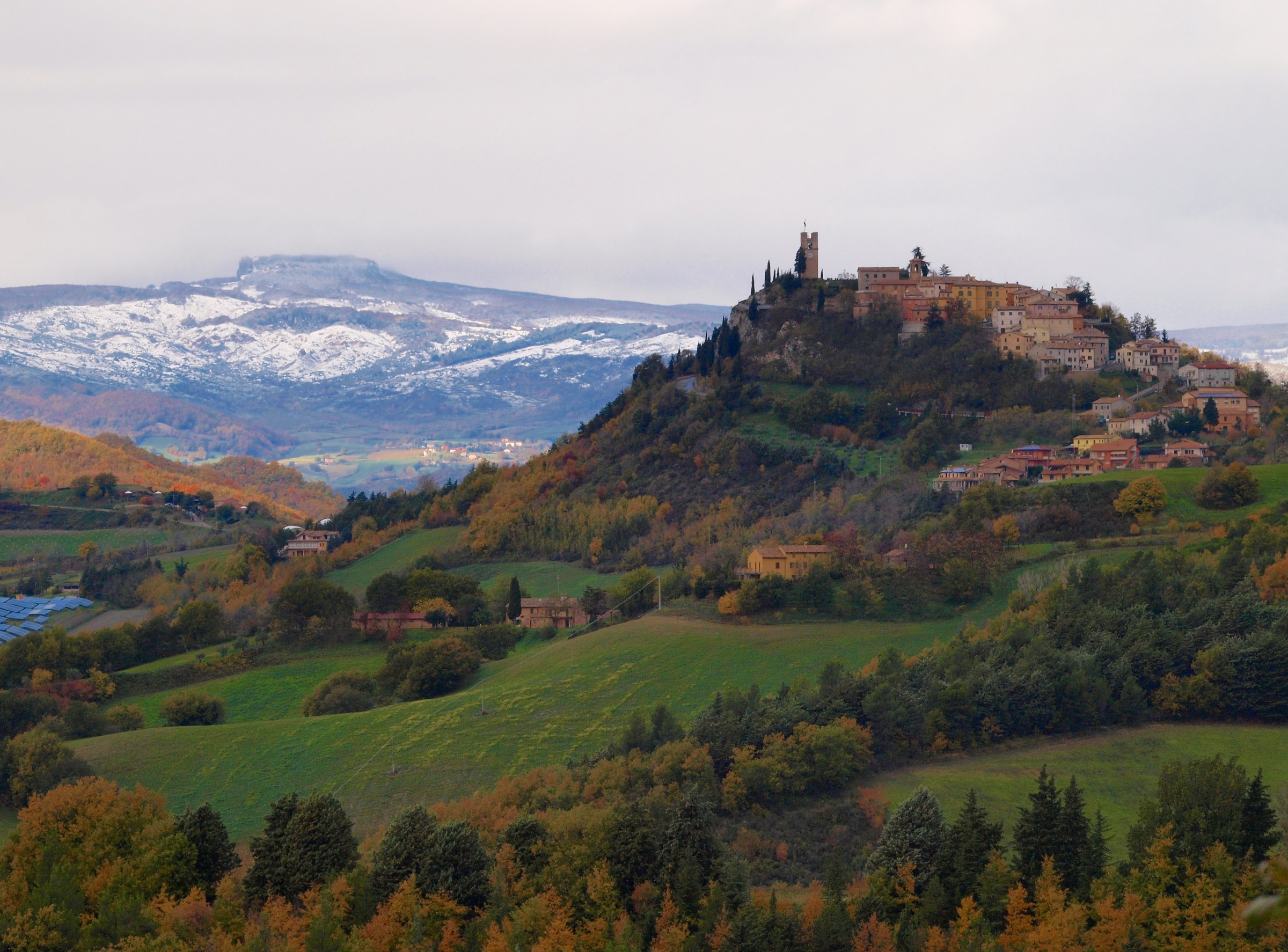 Country of Peglio with behind Carpegna snow covered