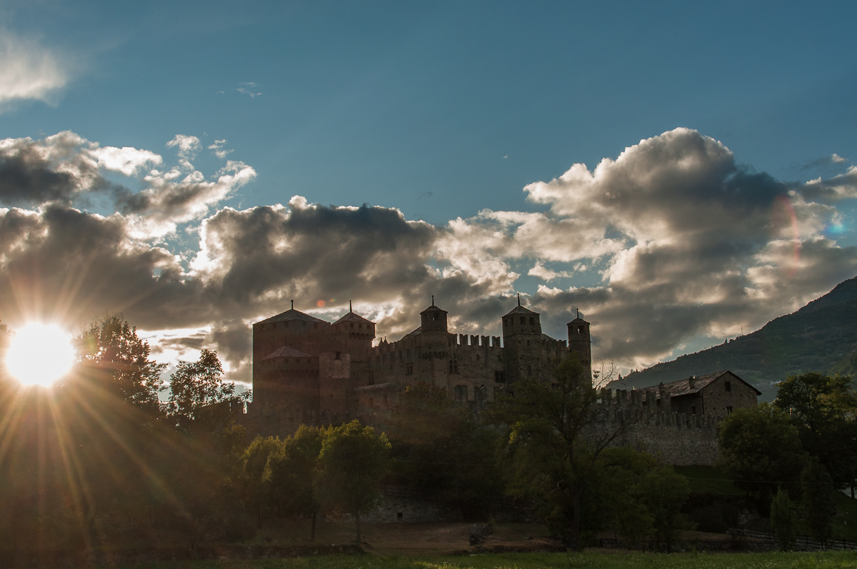 Towers between sun and clouds