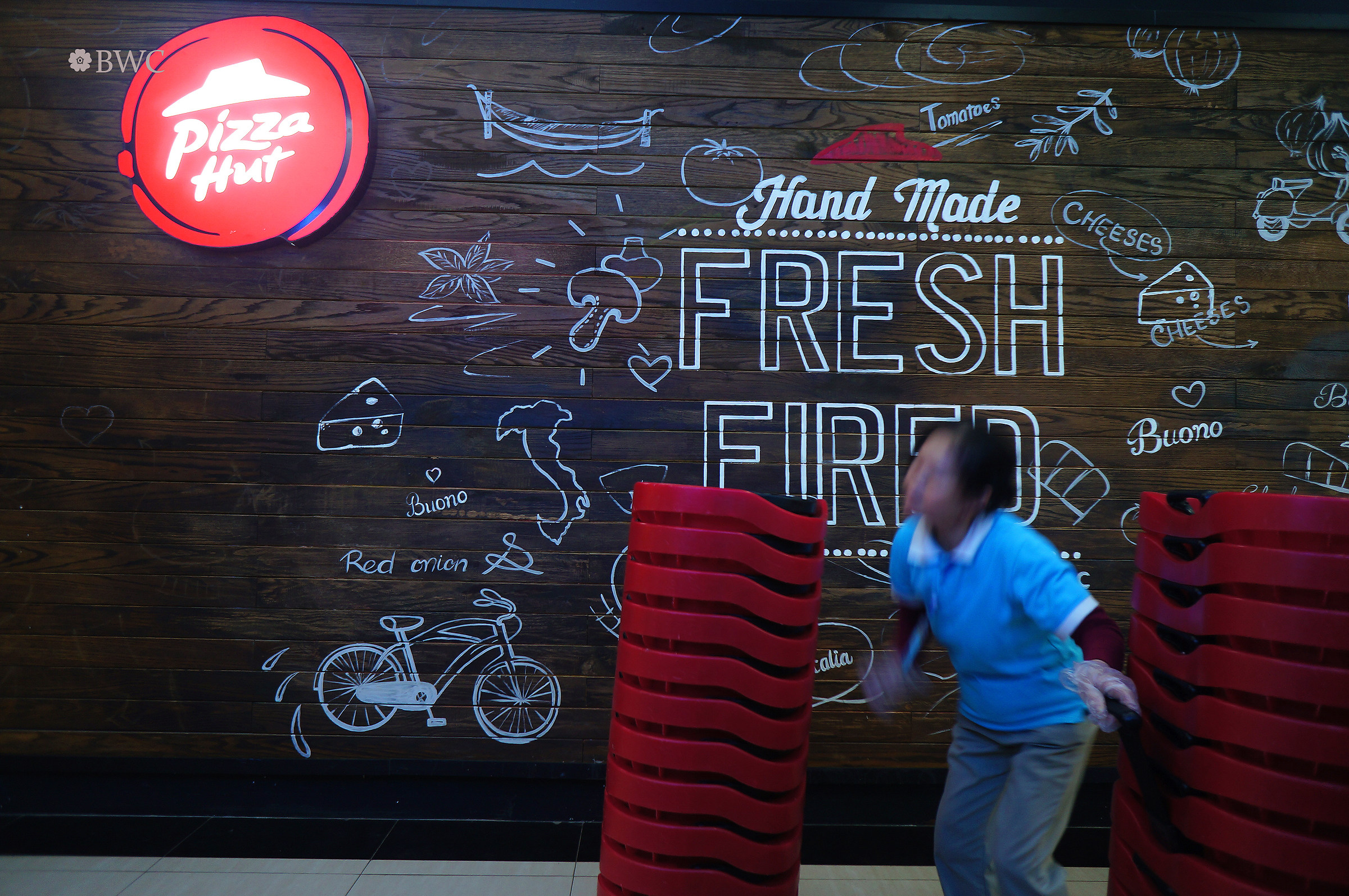 Female Hard Worker Moving Chairs In The Mall