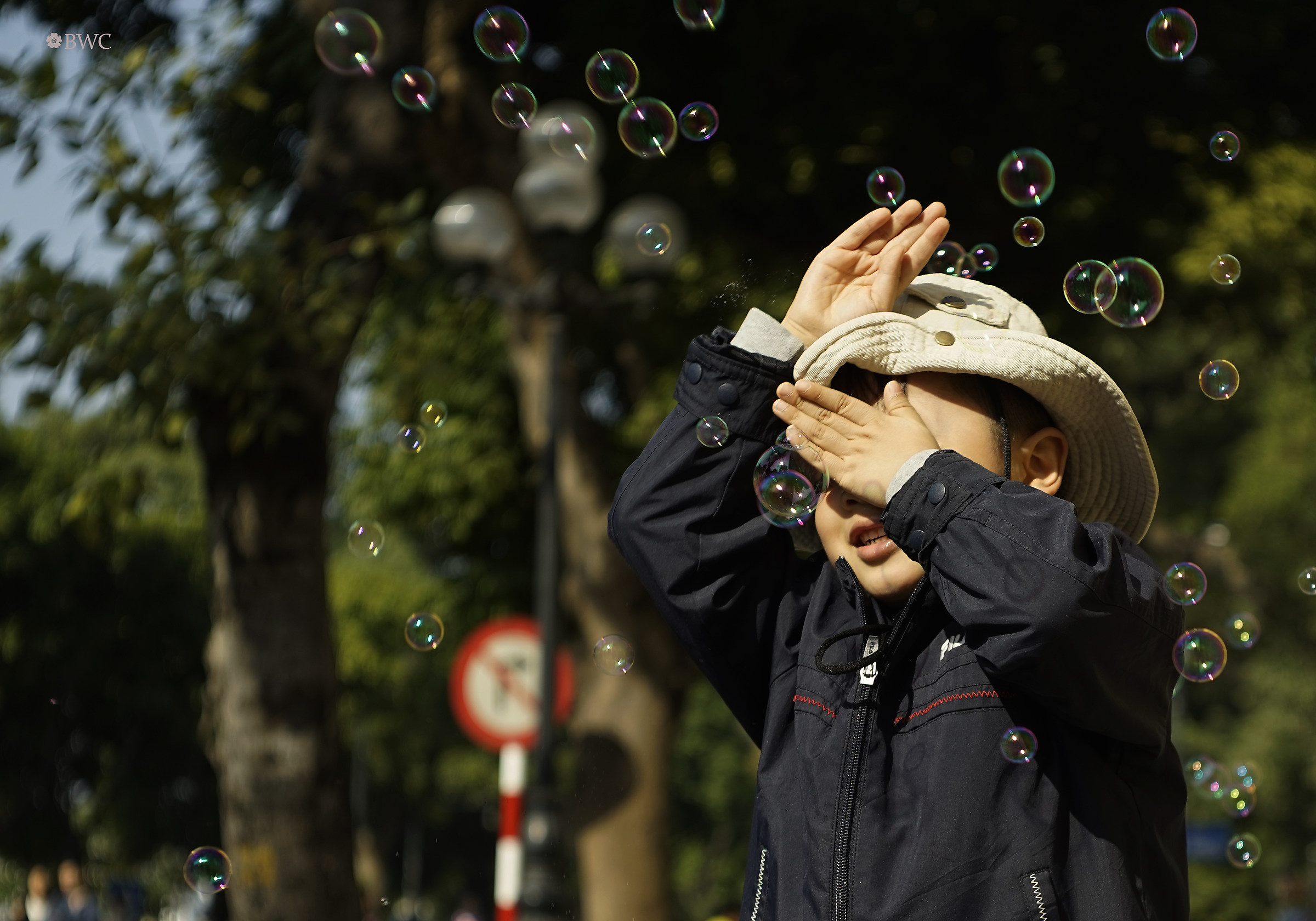 Kid Playing With Soap Bubbles