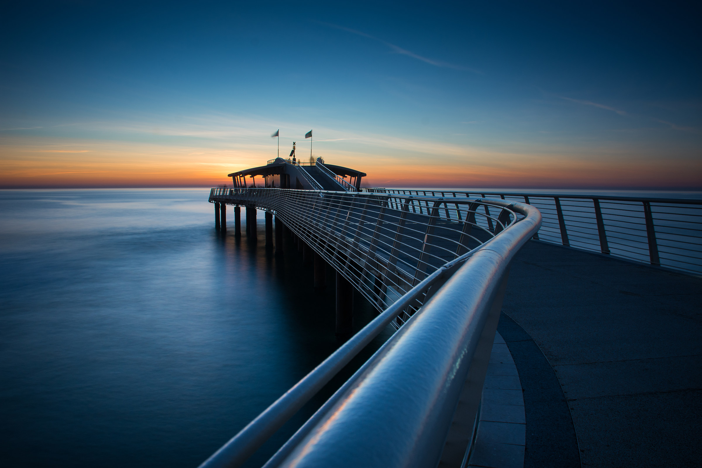 jetty at sunset now blue