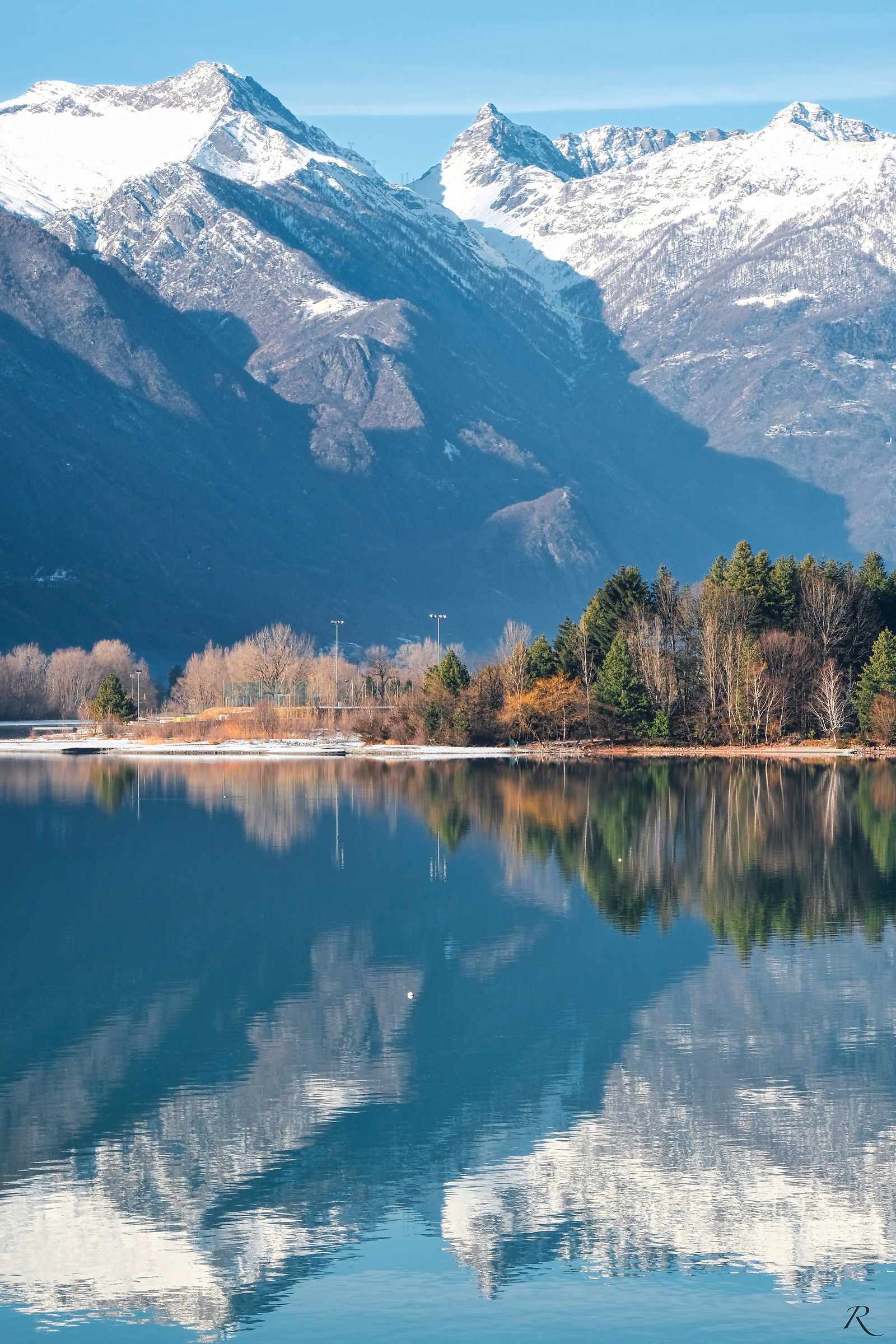 Lepontine Alps reflected on Lake Mezzola