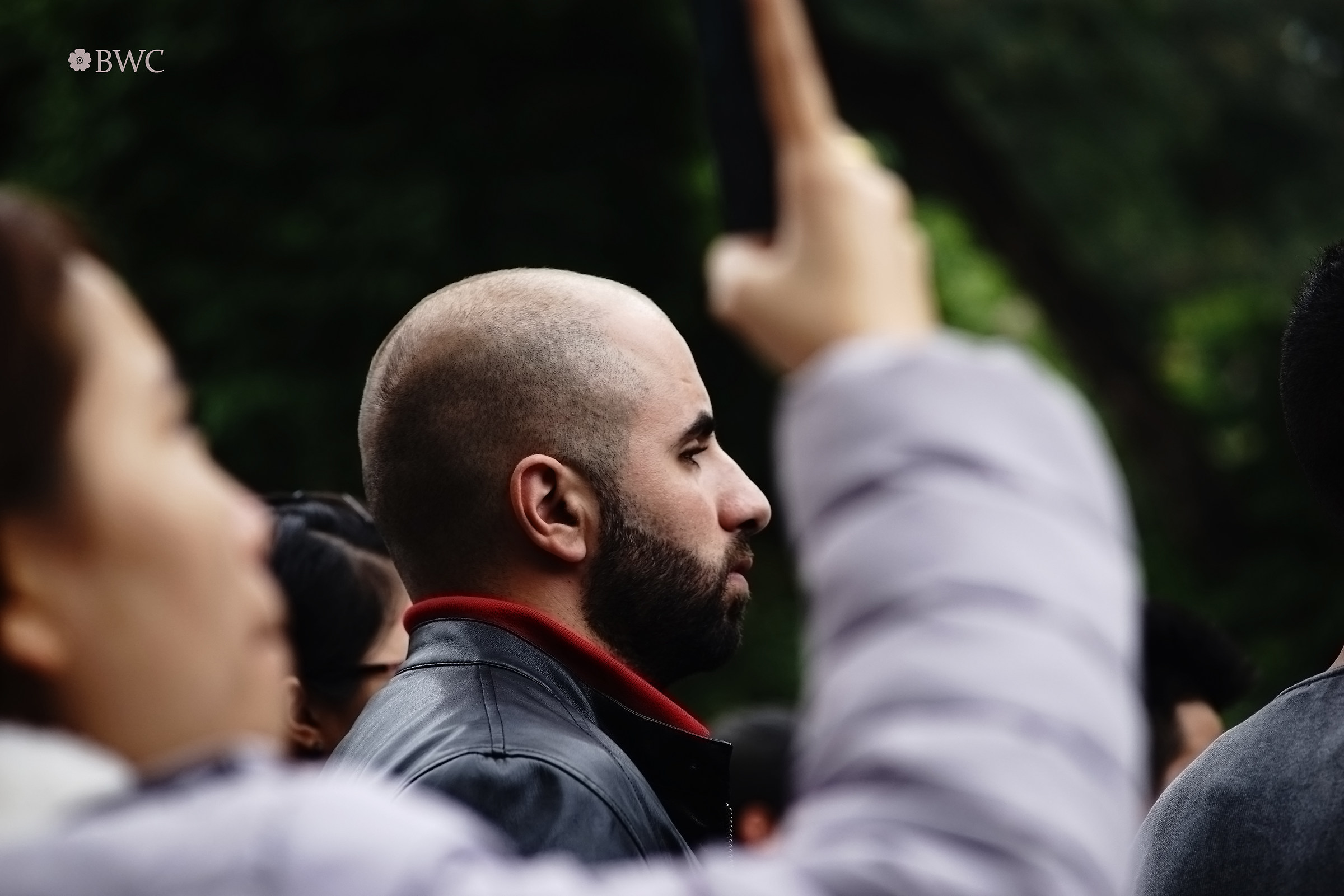 Bald Boy Being Among The Crowd