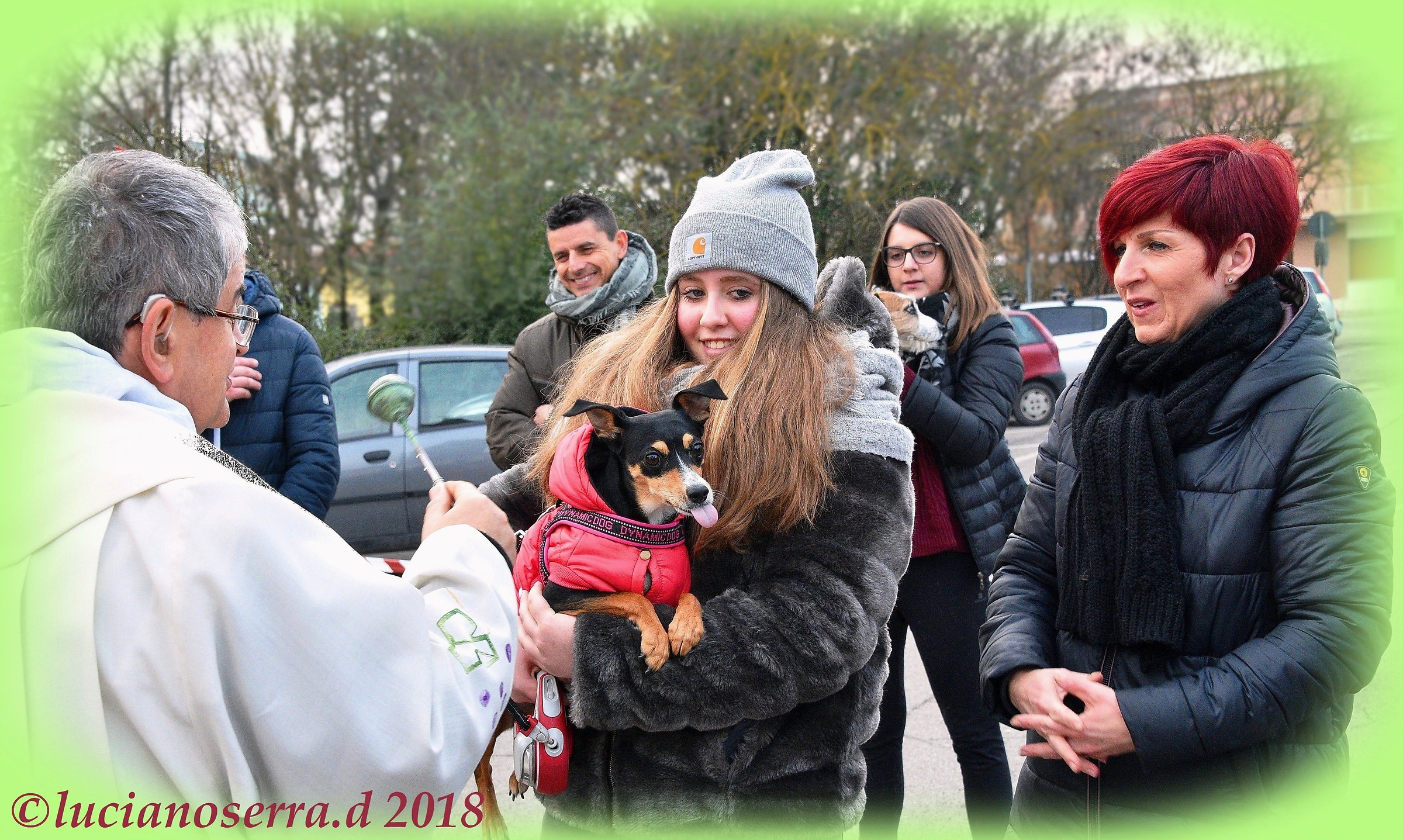 Don Gabriele gives the blessing to a dog