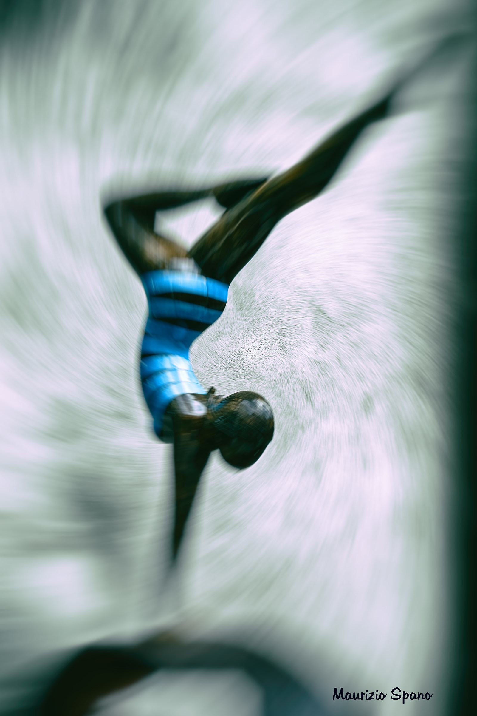 There is a dancer who moves on the wall of a city